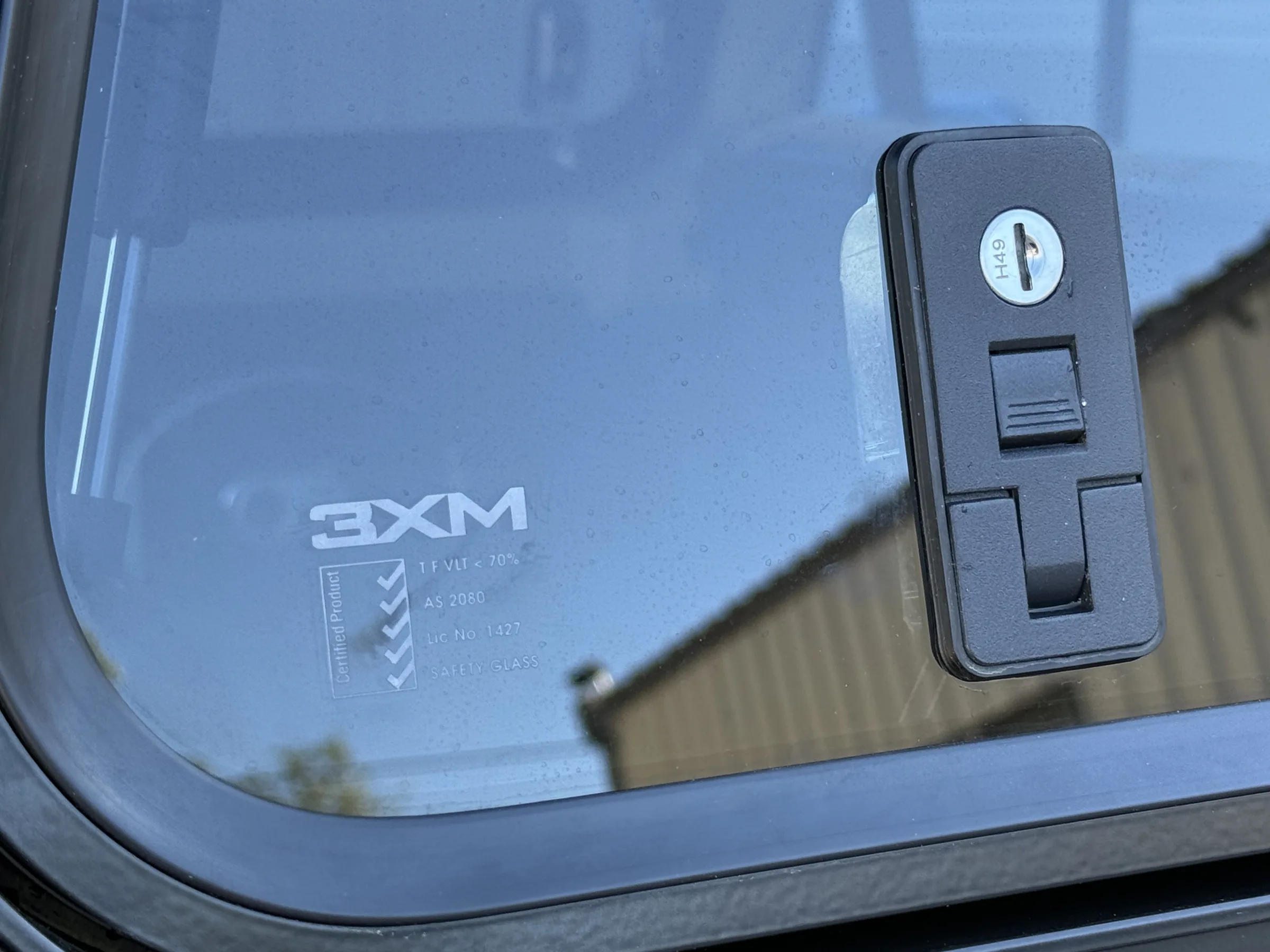 Close-up of a 3XM gull-wing window latch on an FJ60