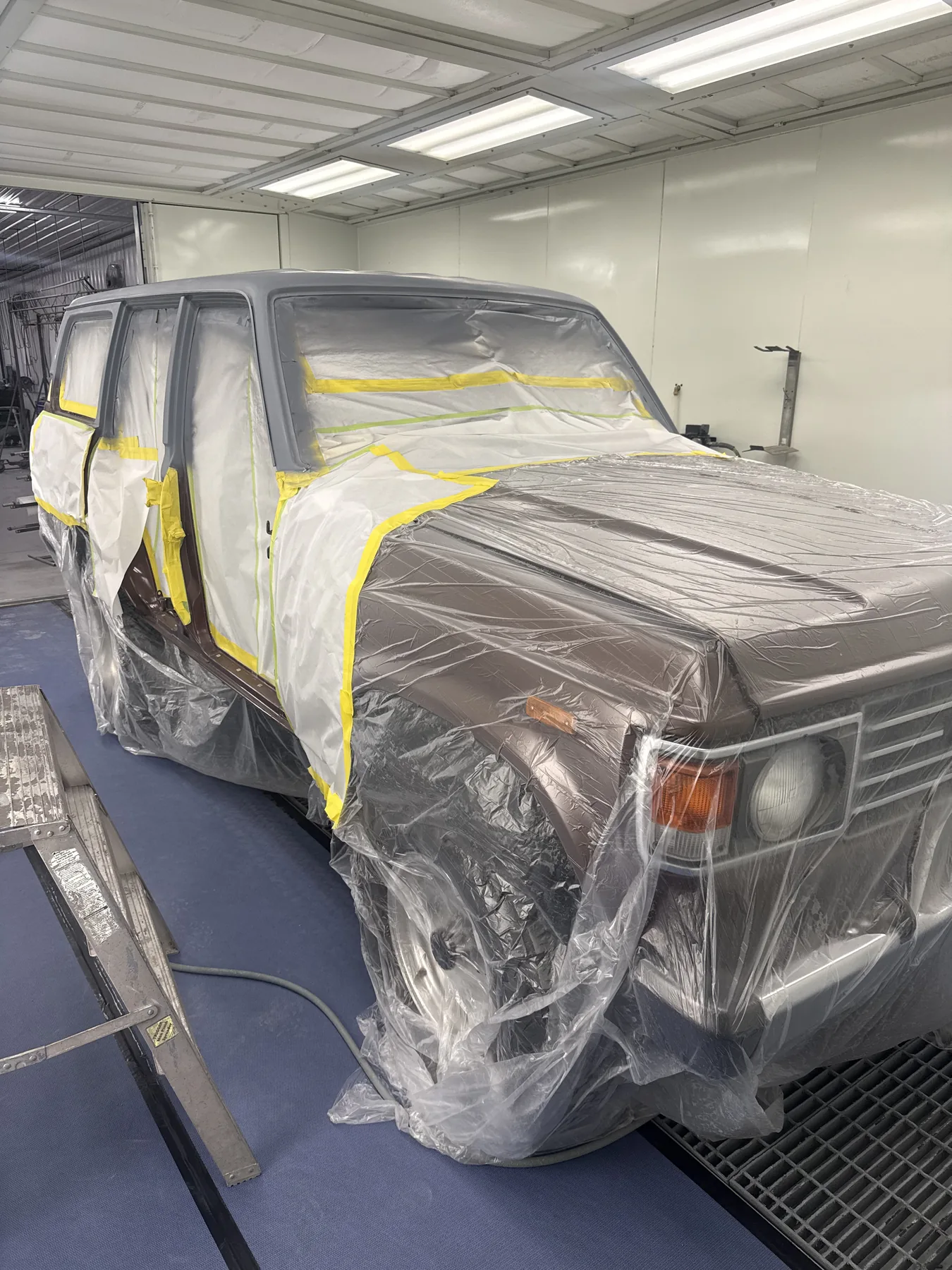 FJ60 masked for paint after replacement of its rusted roof
