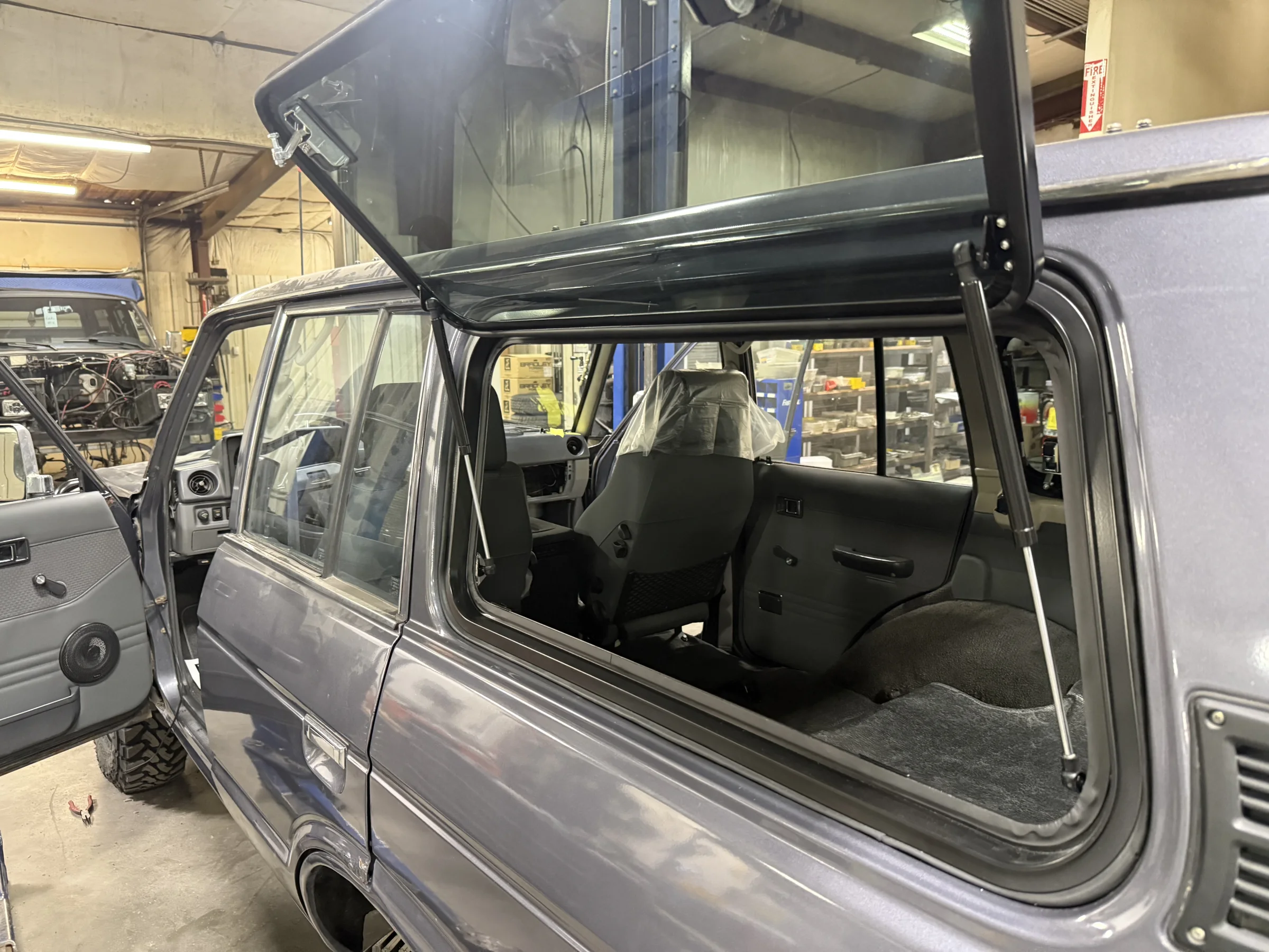 Renewed rear cargo area of the Canadian Toyota HJ60 with its side window open