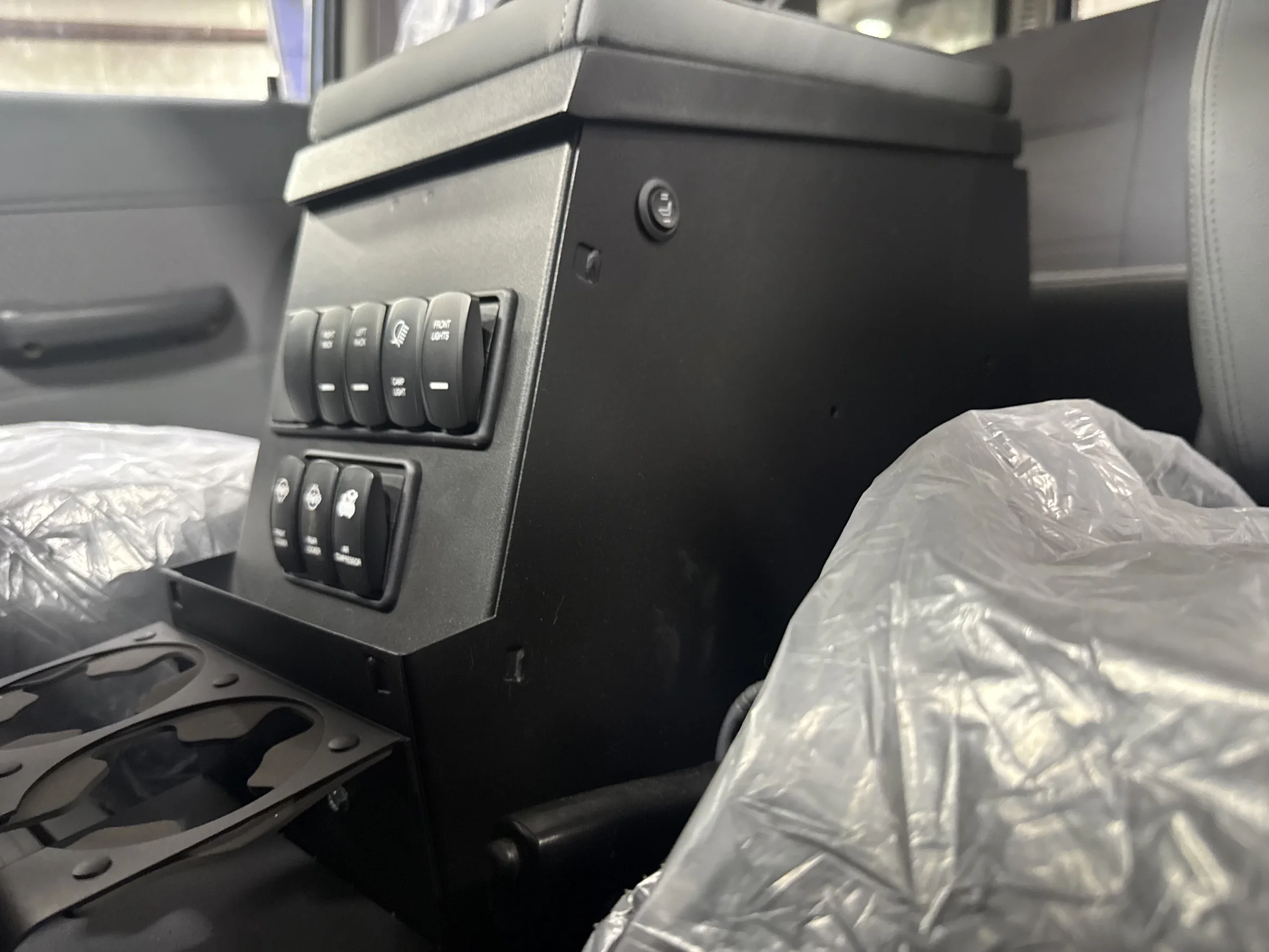 PRLC-modified Tuffy center console with integrated accessory switches in the HJ60