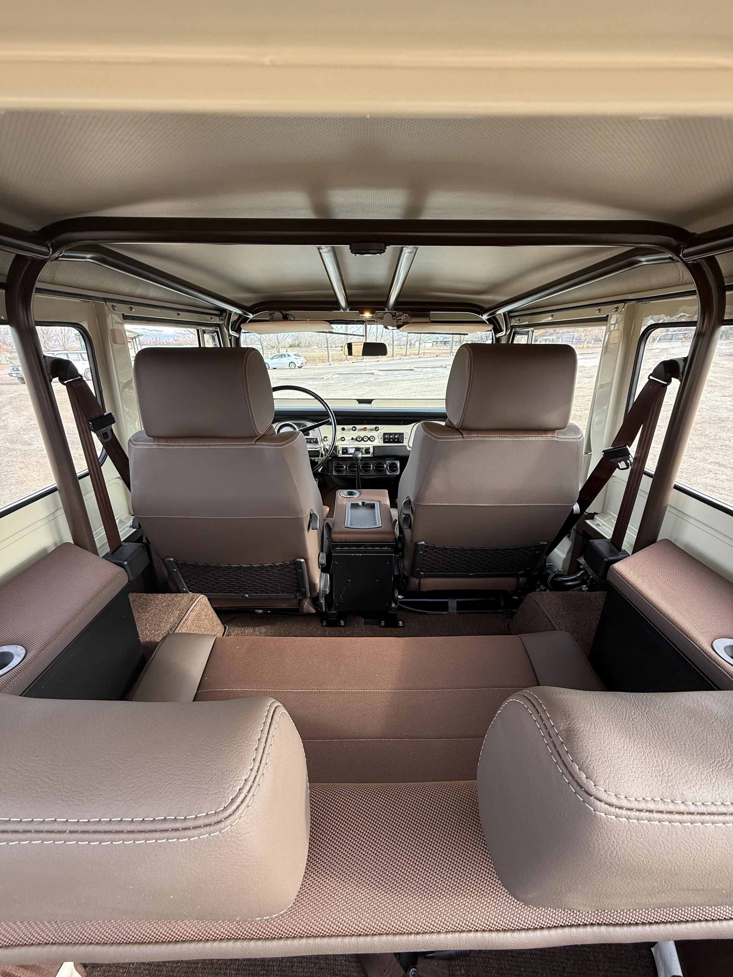 Full custom interior of the cream FJ40 viewed from the rear