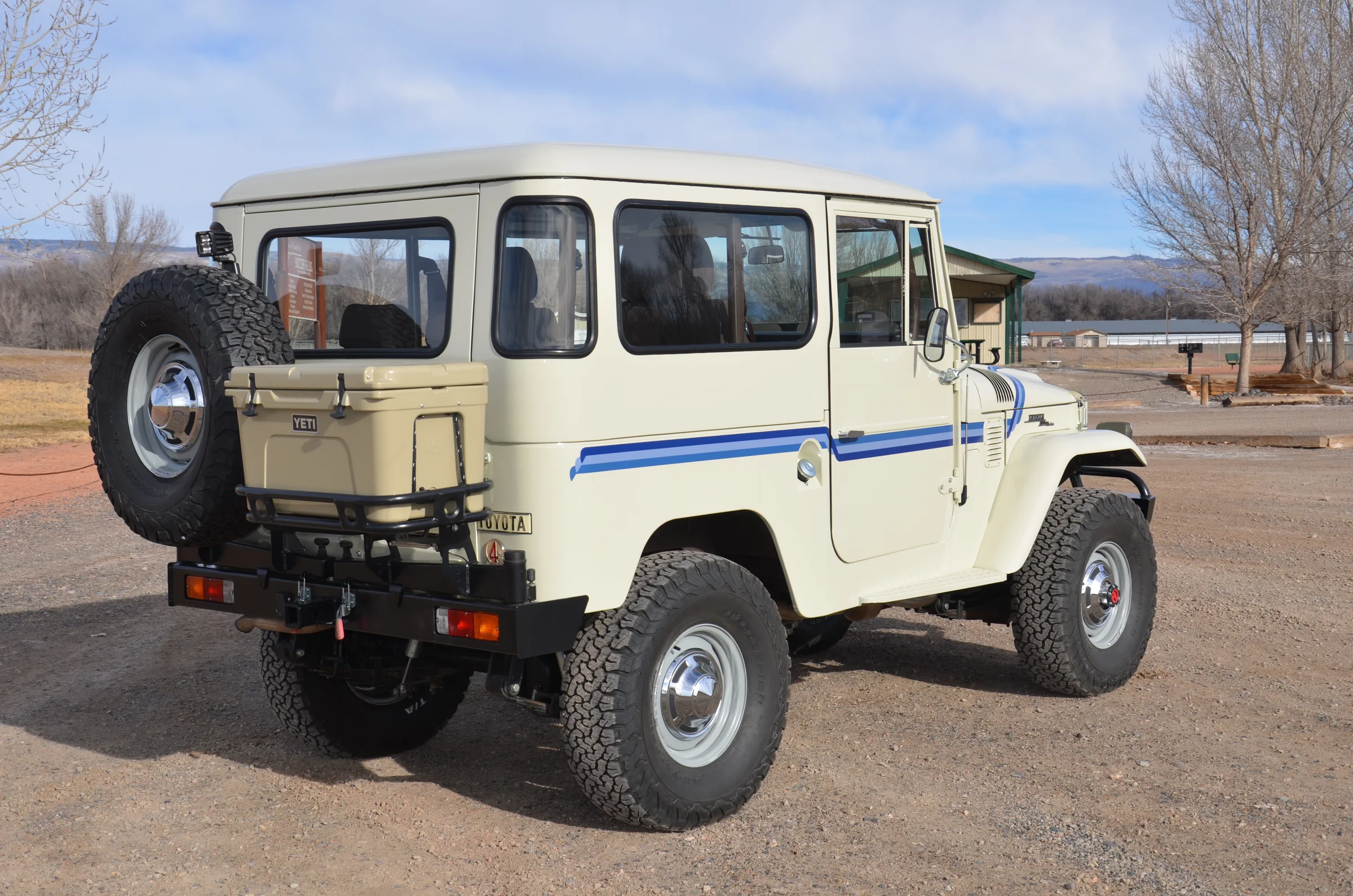 Rear three-quarter view of the cream FJ40 with its restored hard top