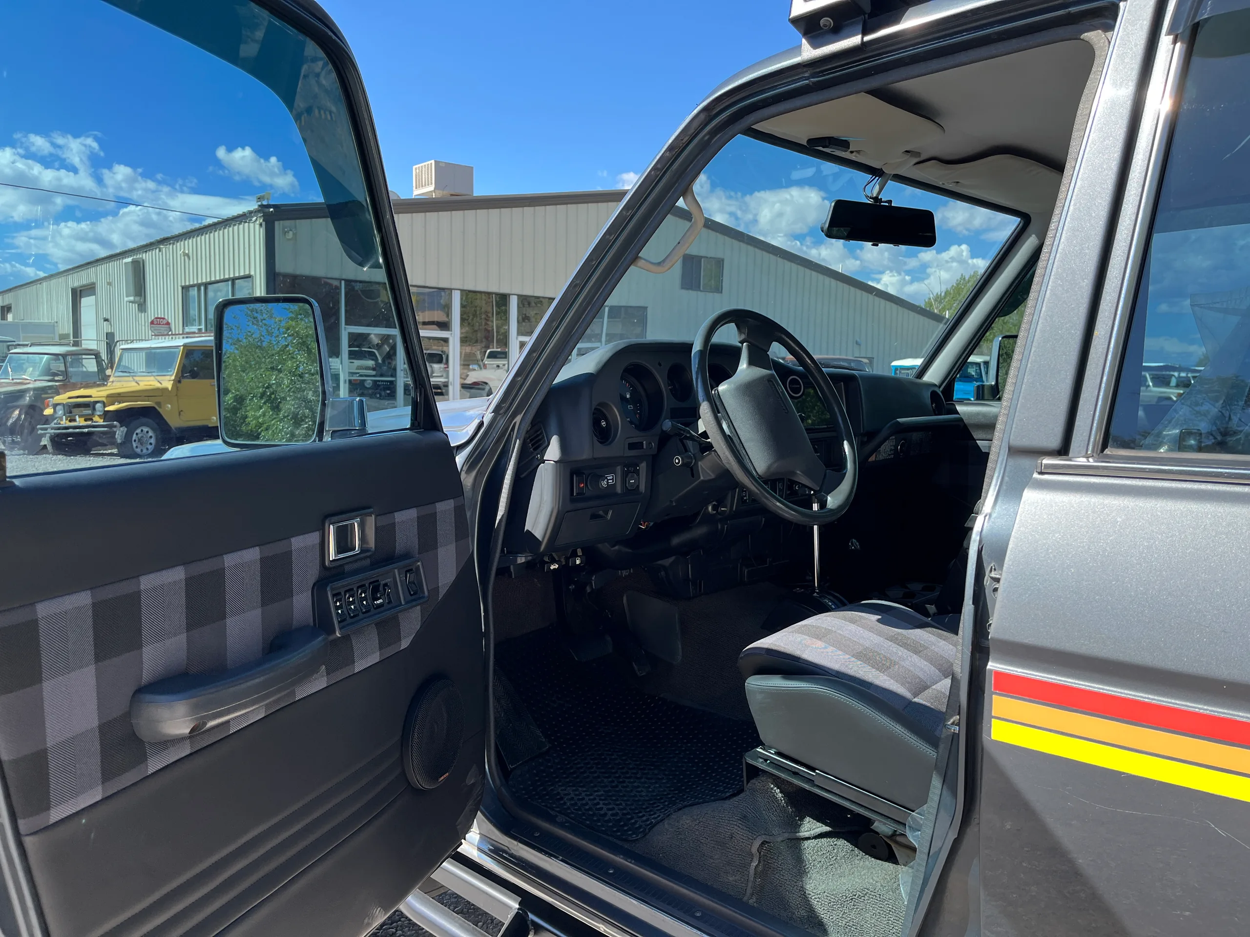 Updated driver area and matching door-panel upholstery in the grey FJ62
