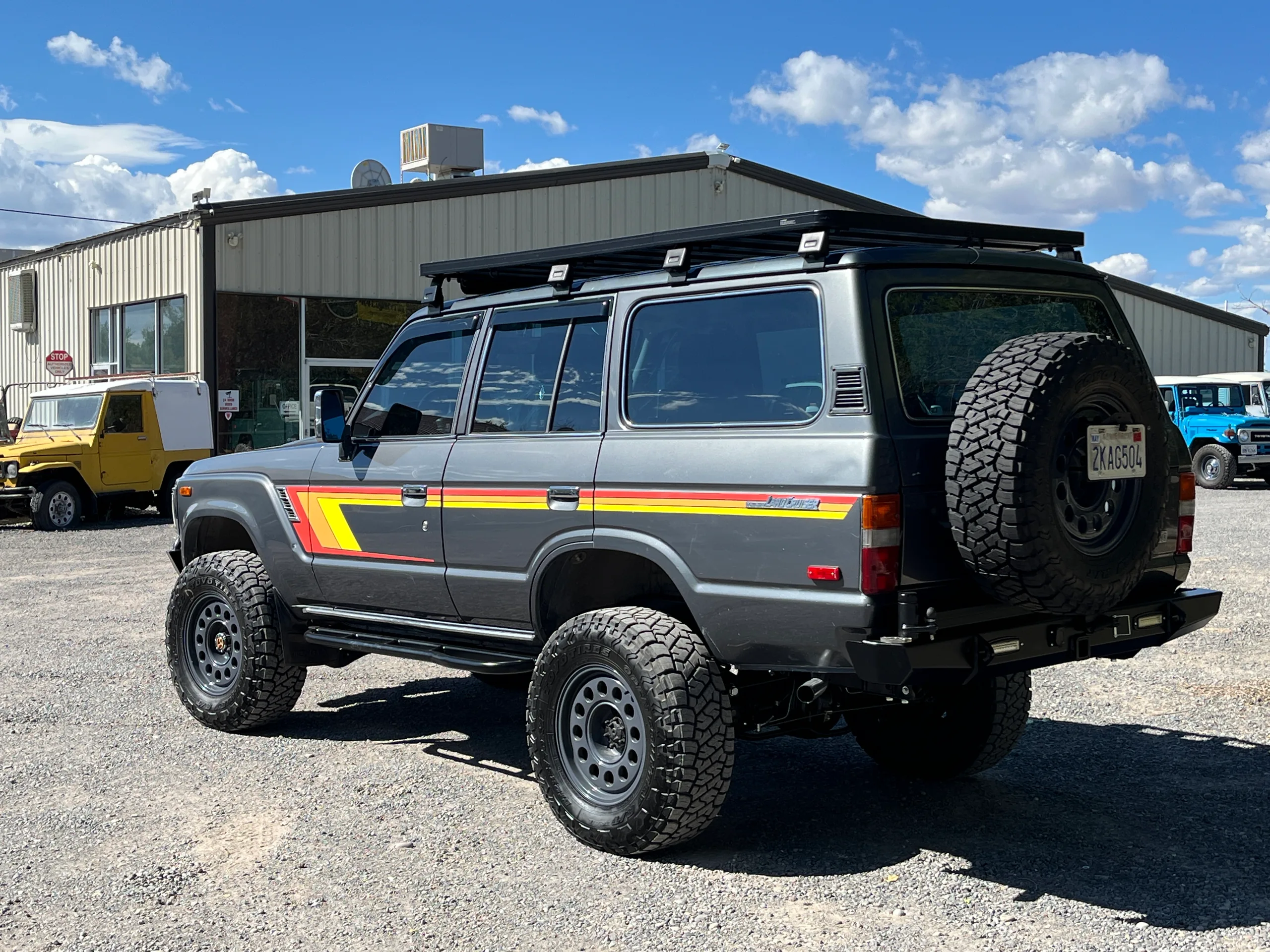 Grey FJ62 with 80 Series frame conversion and side stripes