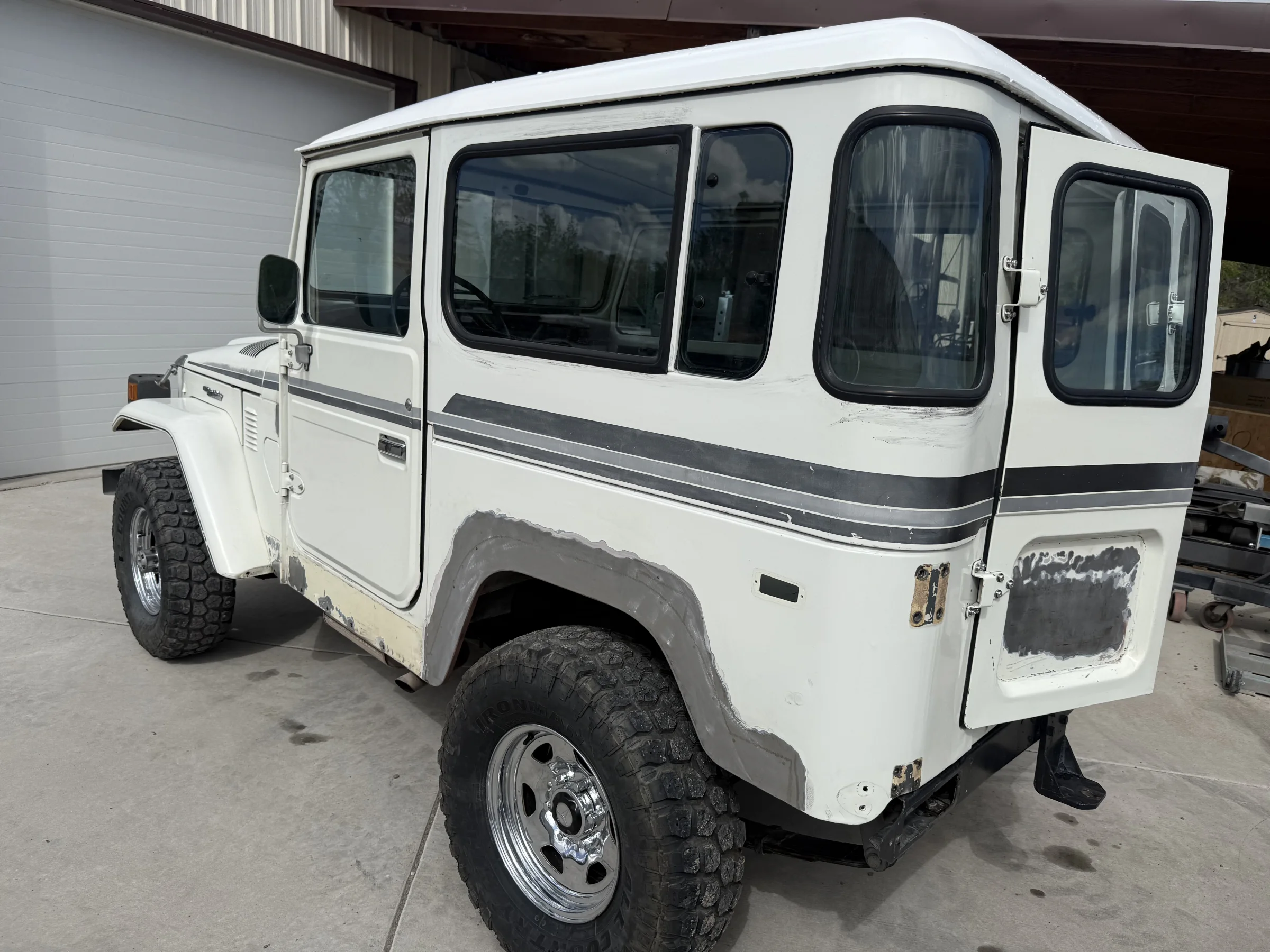 White 1983 FJ40 before removal of its fender flares, stainless cladding, CB antenna, and other accessories