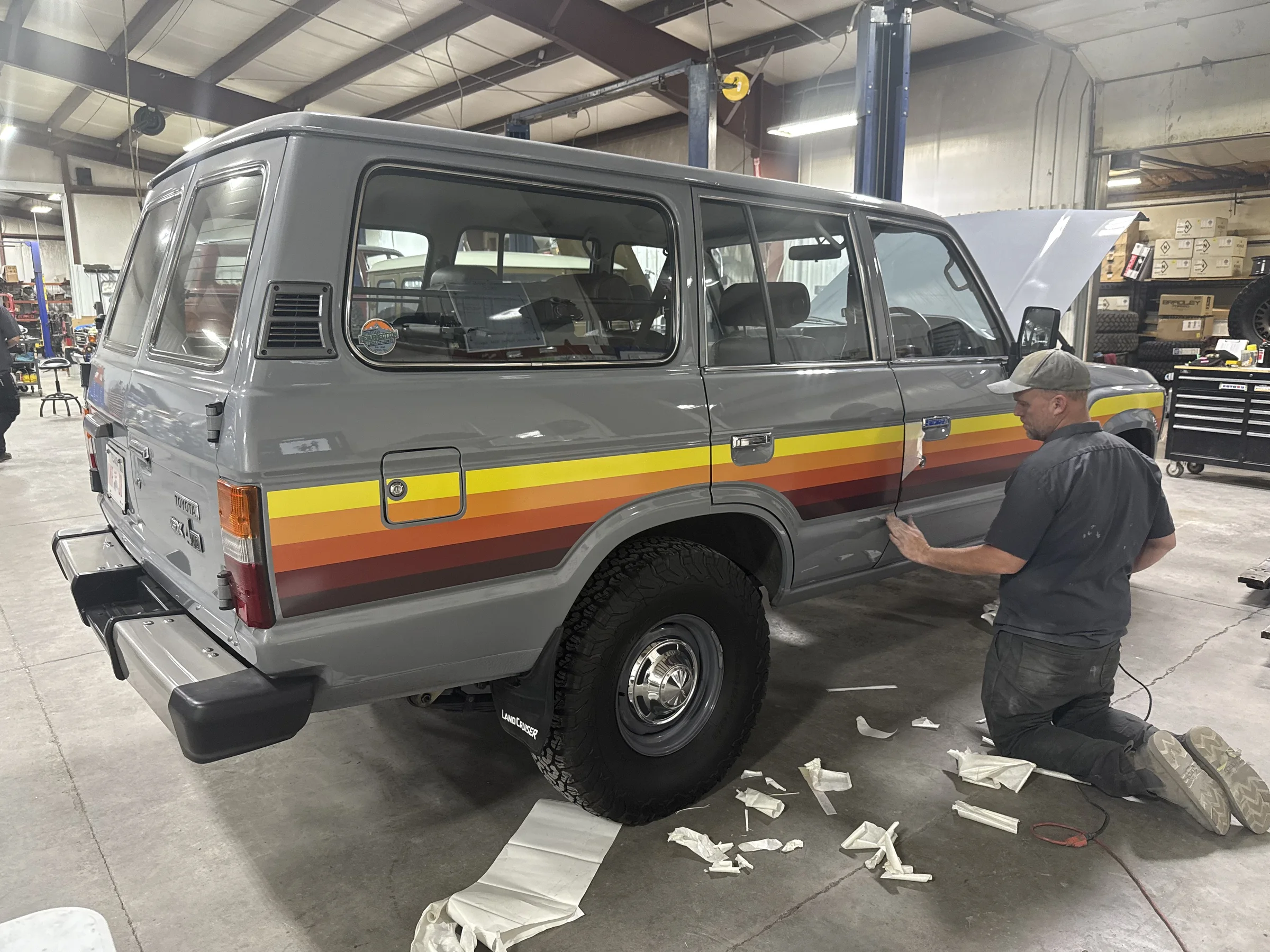 Touge Nation stripes being installed on the gray HJ60