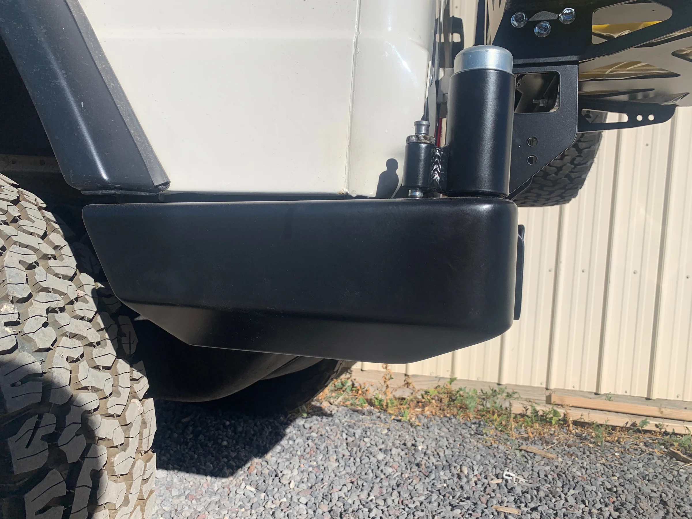 Close-up of the custom fabricated rear bumper corner on a classic Mercedes G Wagon
