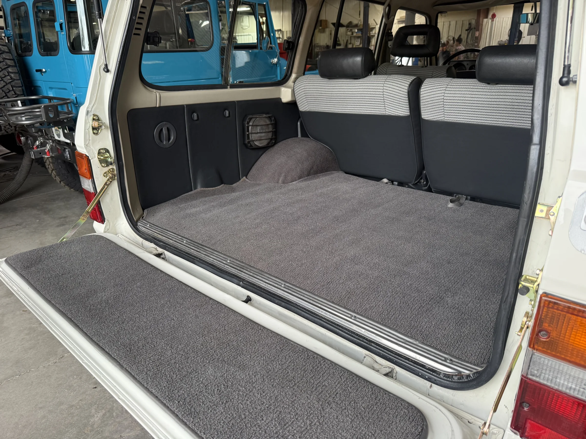 Finished carpeted cargo area of the white Toyota FJ62