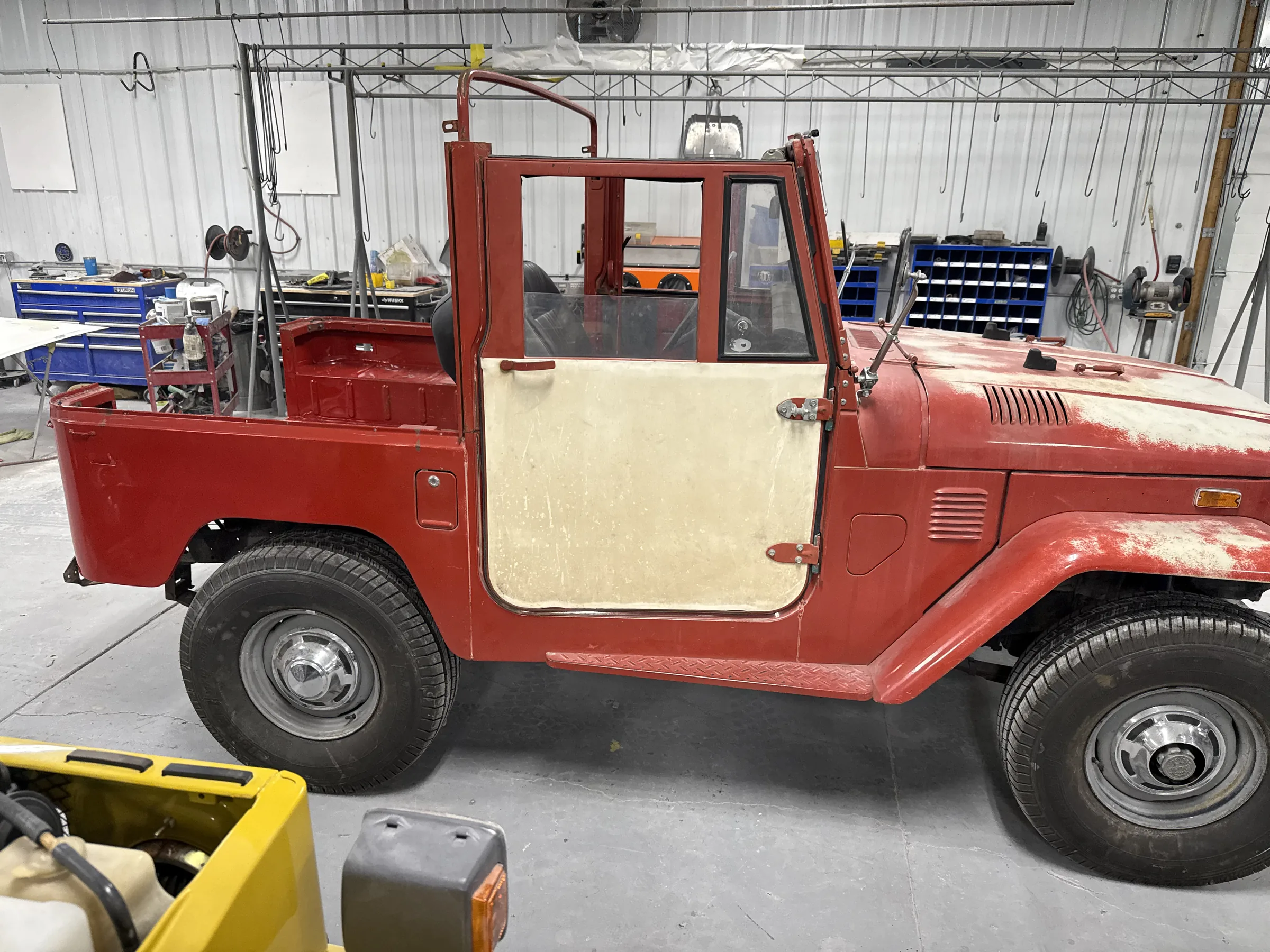 Patina FJ40 in the shop during targeted rust and body repairs