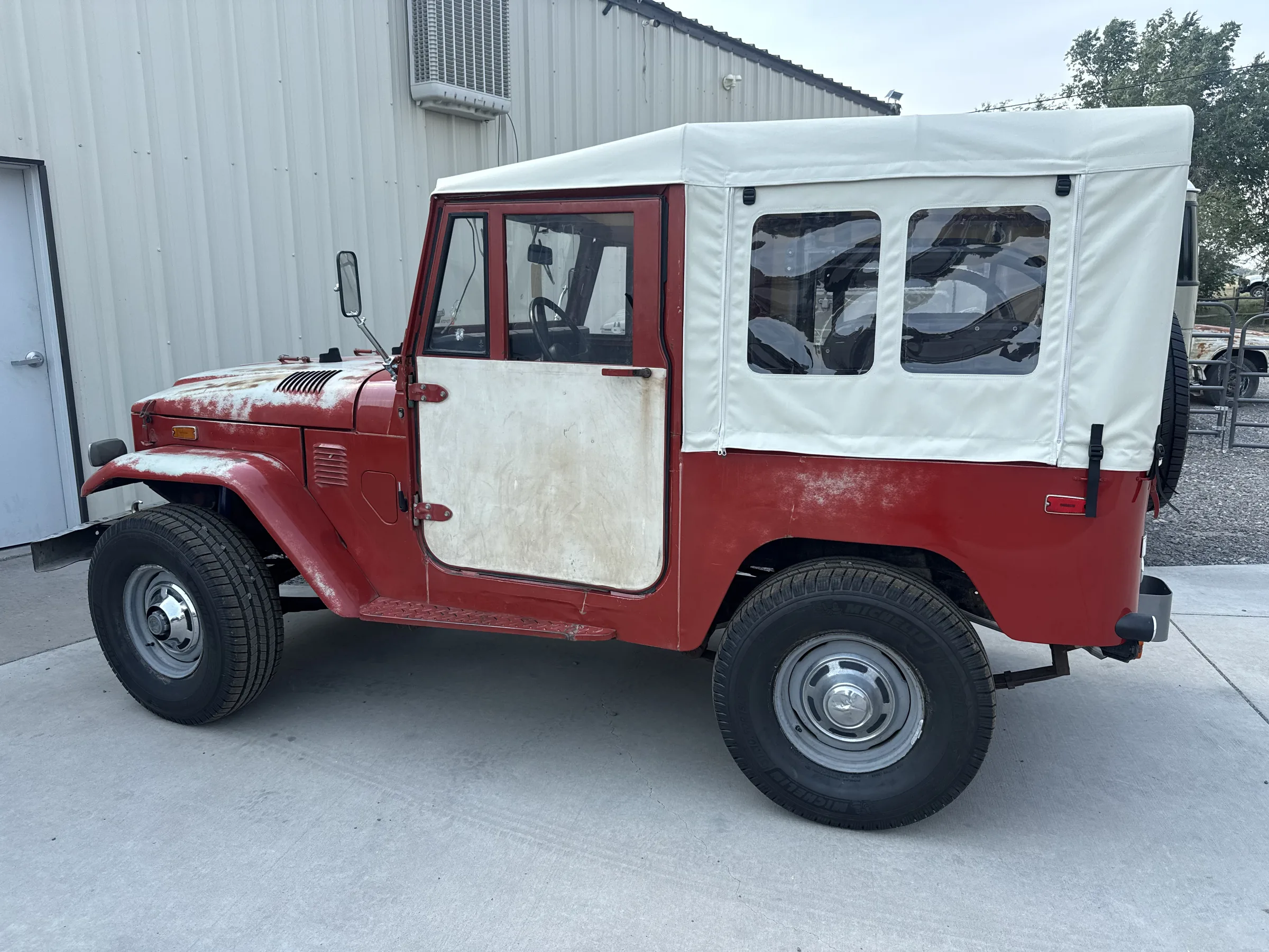 Side view of the preserved FJ40 and its custom replacement soft top