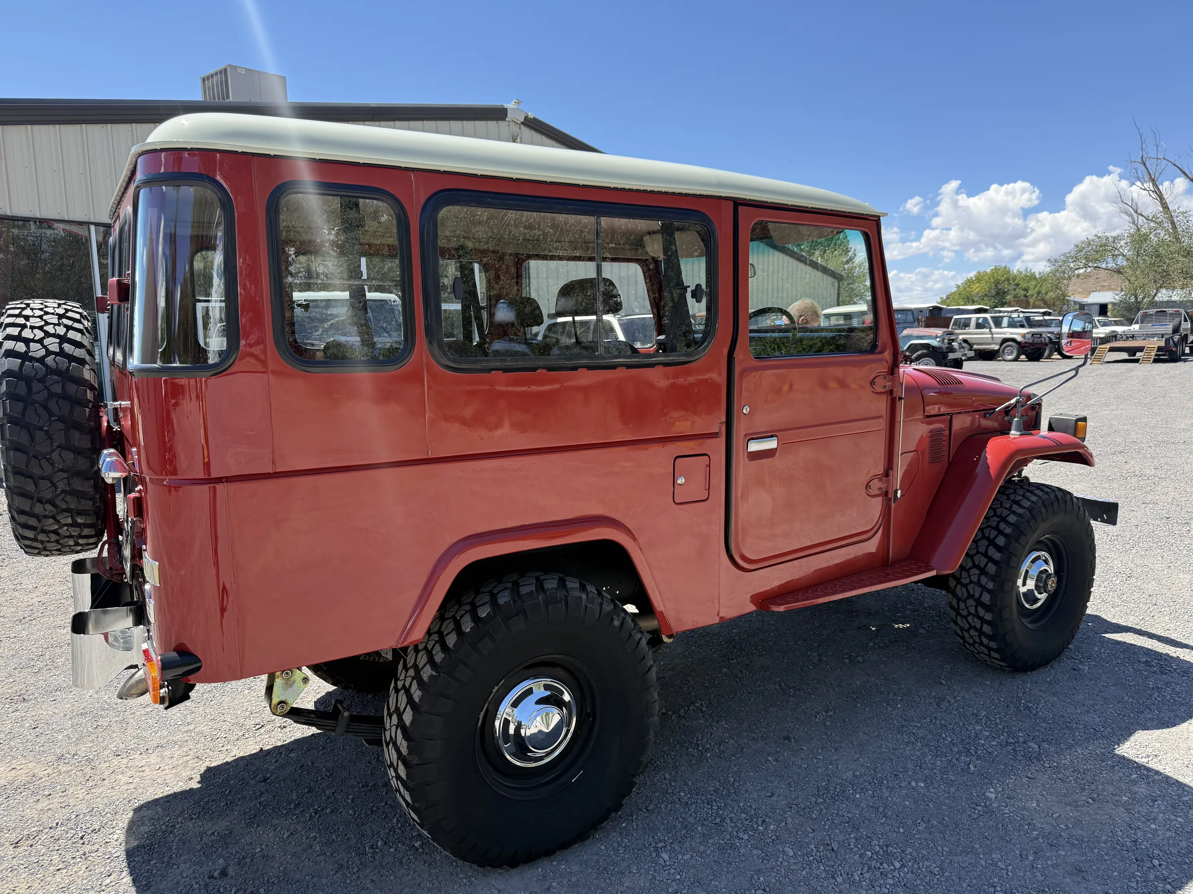 Rear three-quarter view of a red Toyota Land Cruiser BJ46