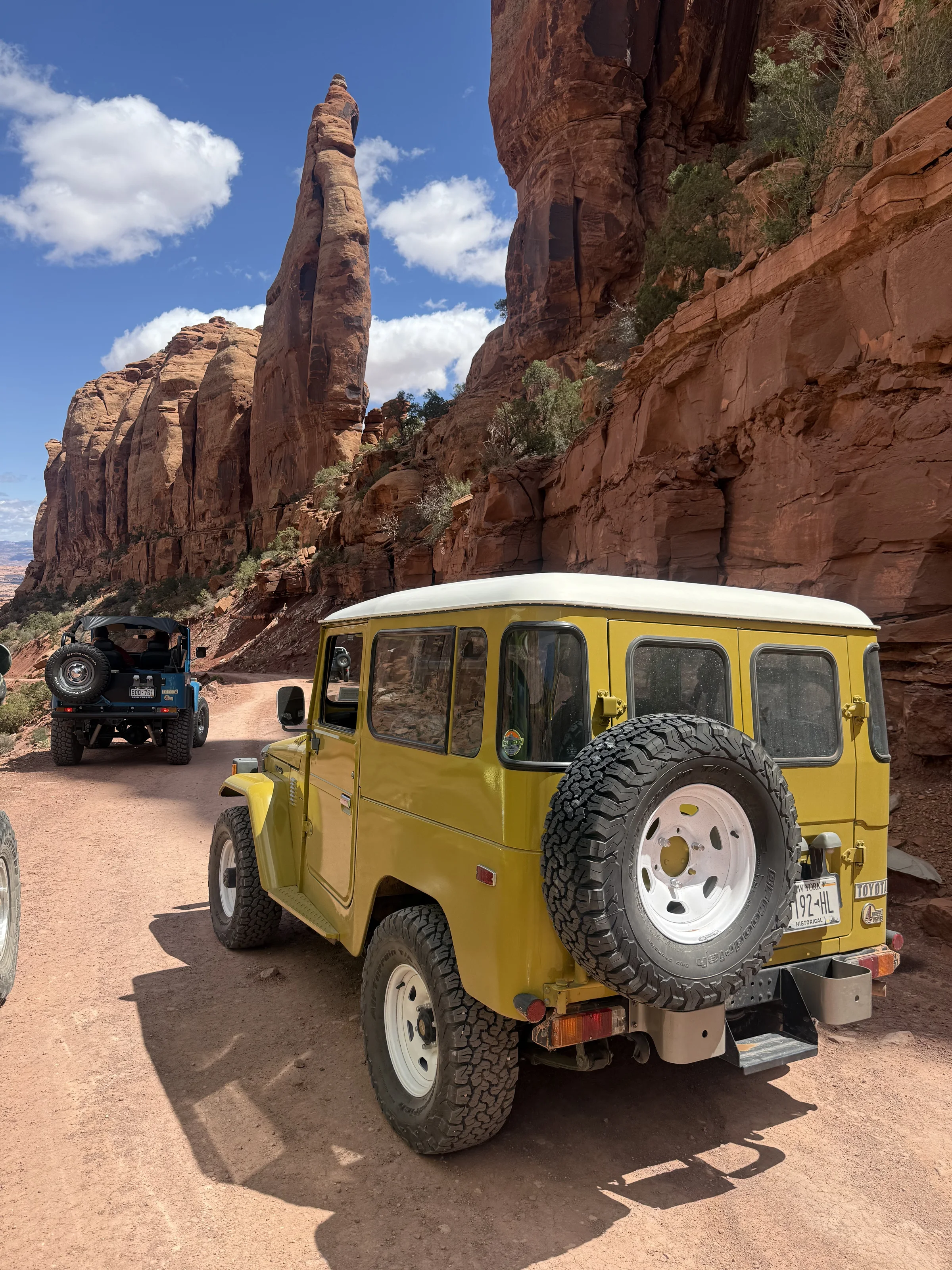 Rear view of the yellow survivor FJ40 on a Moab trail