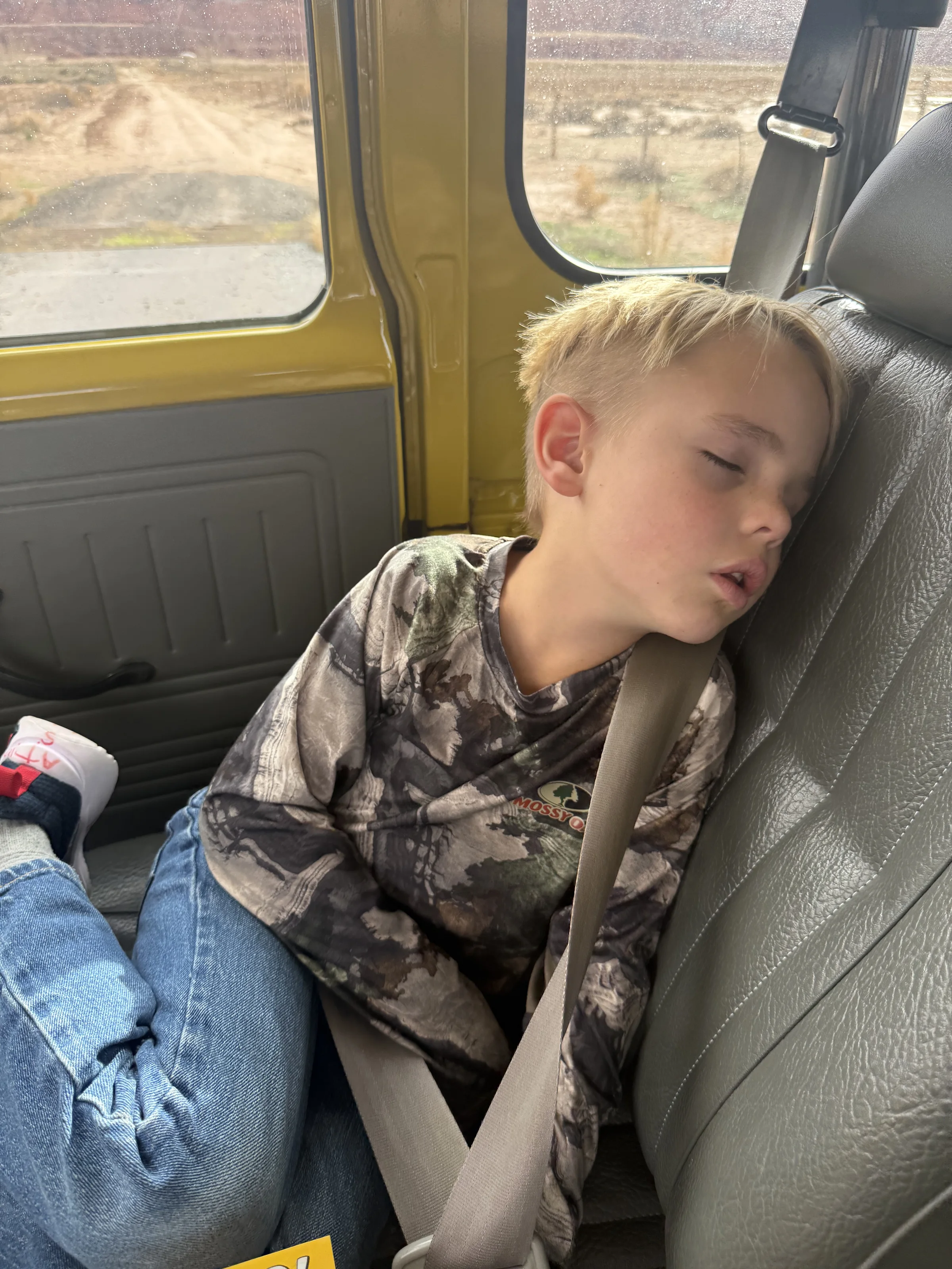 Young passenger sleeping during the classic Land Cruiser road trip