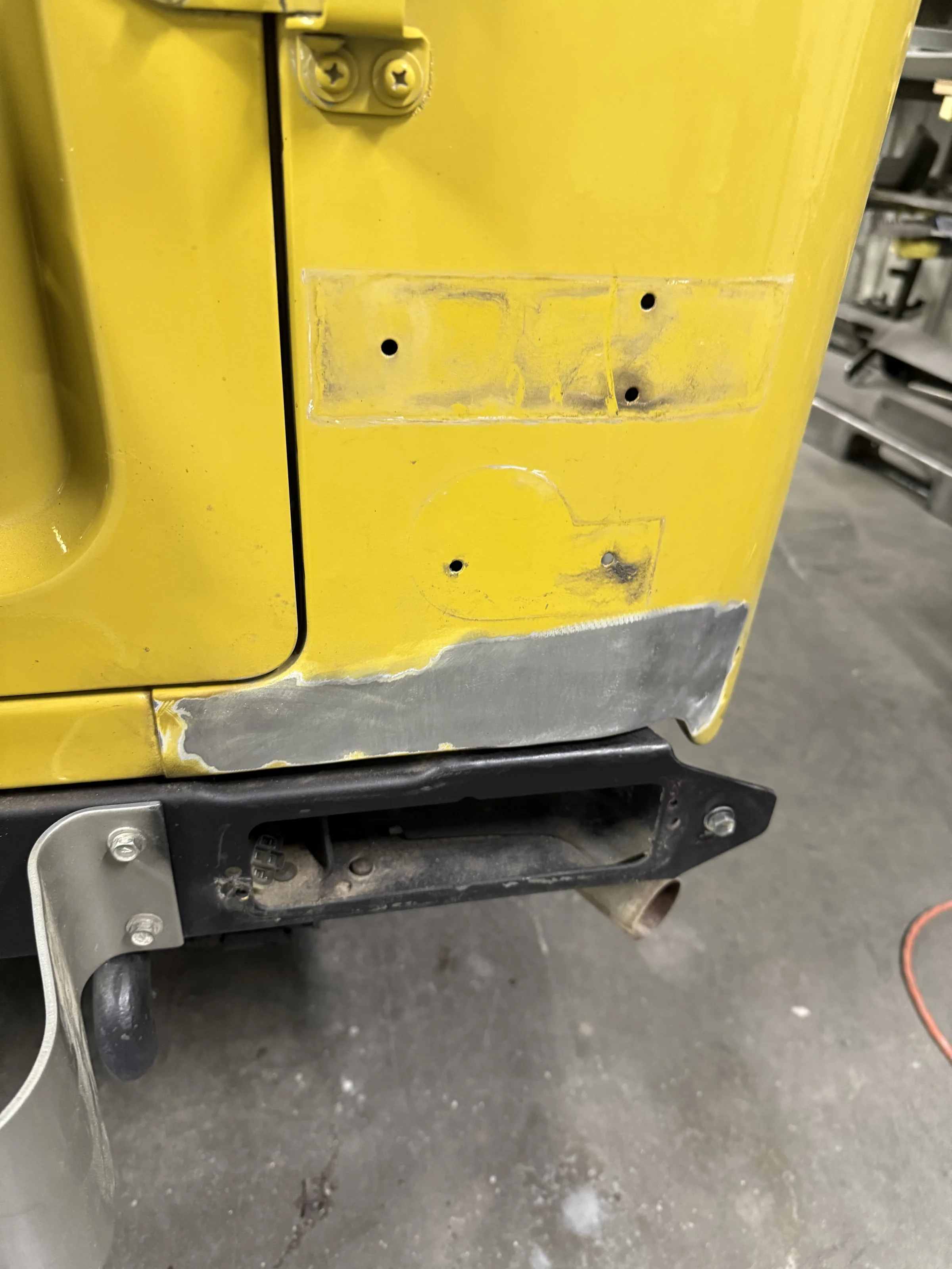 Rust repair area exposed at the bottom of the FJ40 bib