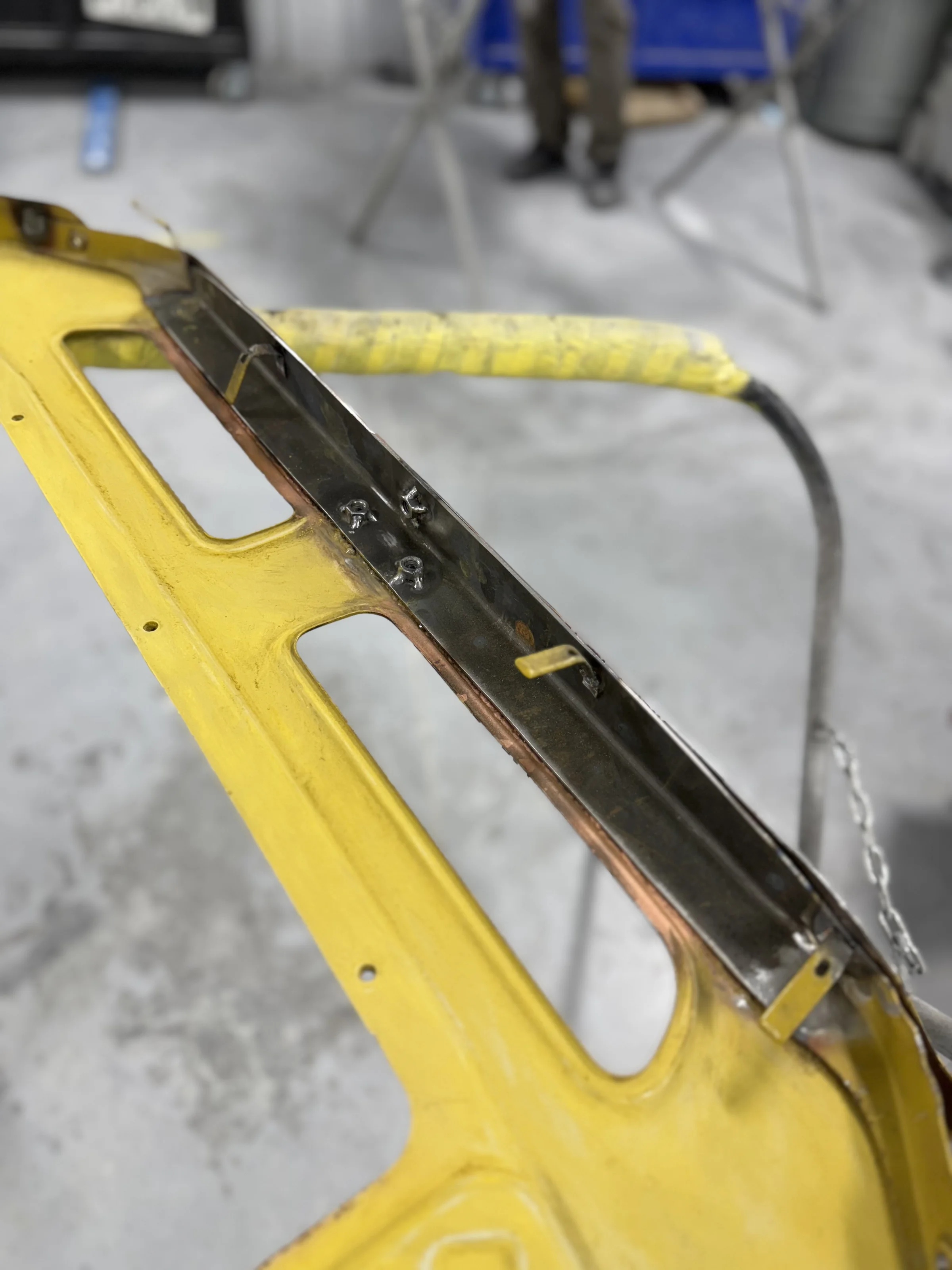Separated FJ40 bib pieces revealing the rust between panels