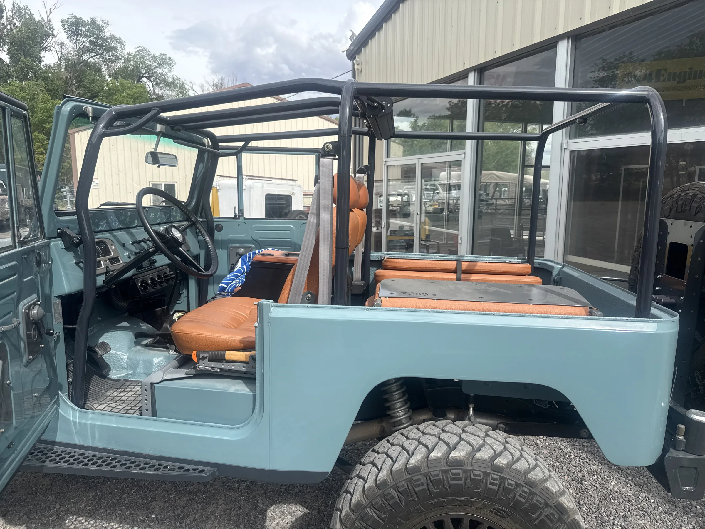 Side view into the open cabin of the custom blue FJ40