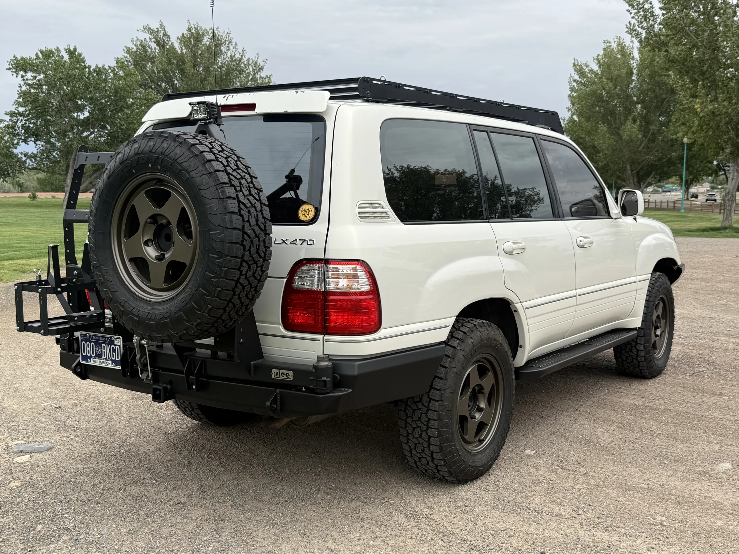 Rear three-quarter view of a modified white Lexus LX470