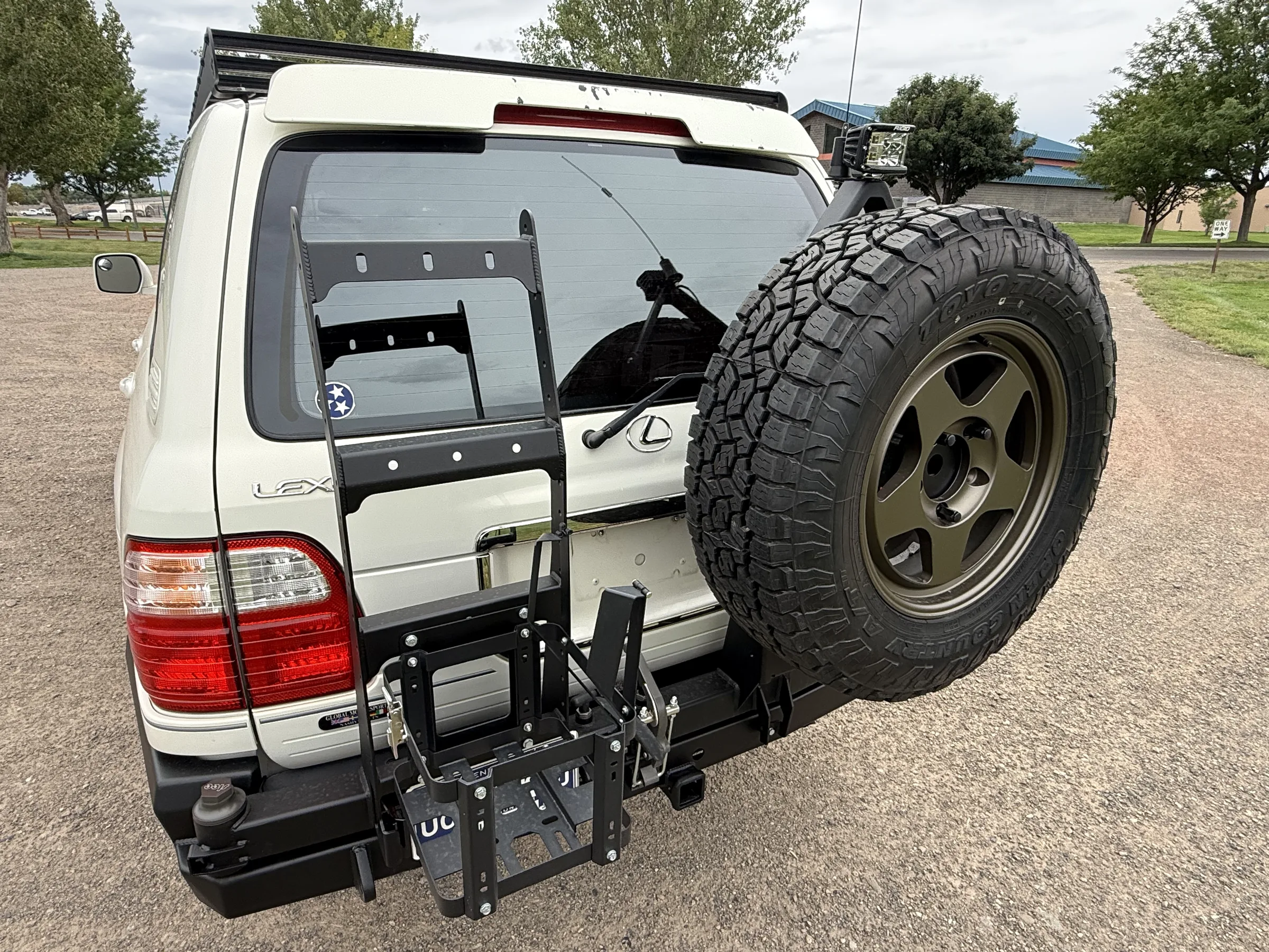 Slee rear bumper, spare-tire carrier, and Bradley wheel on a white Lexus LX470
