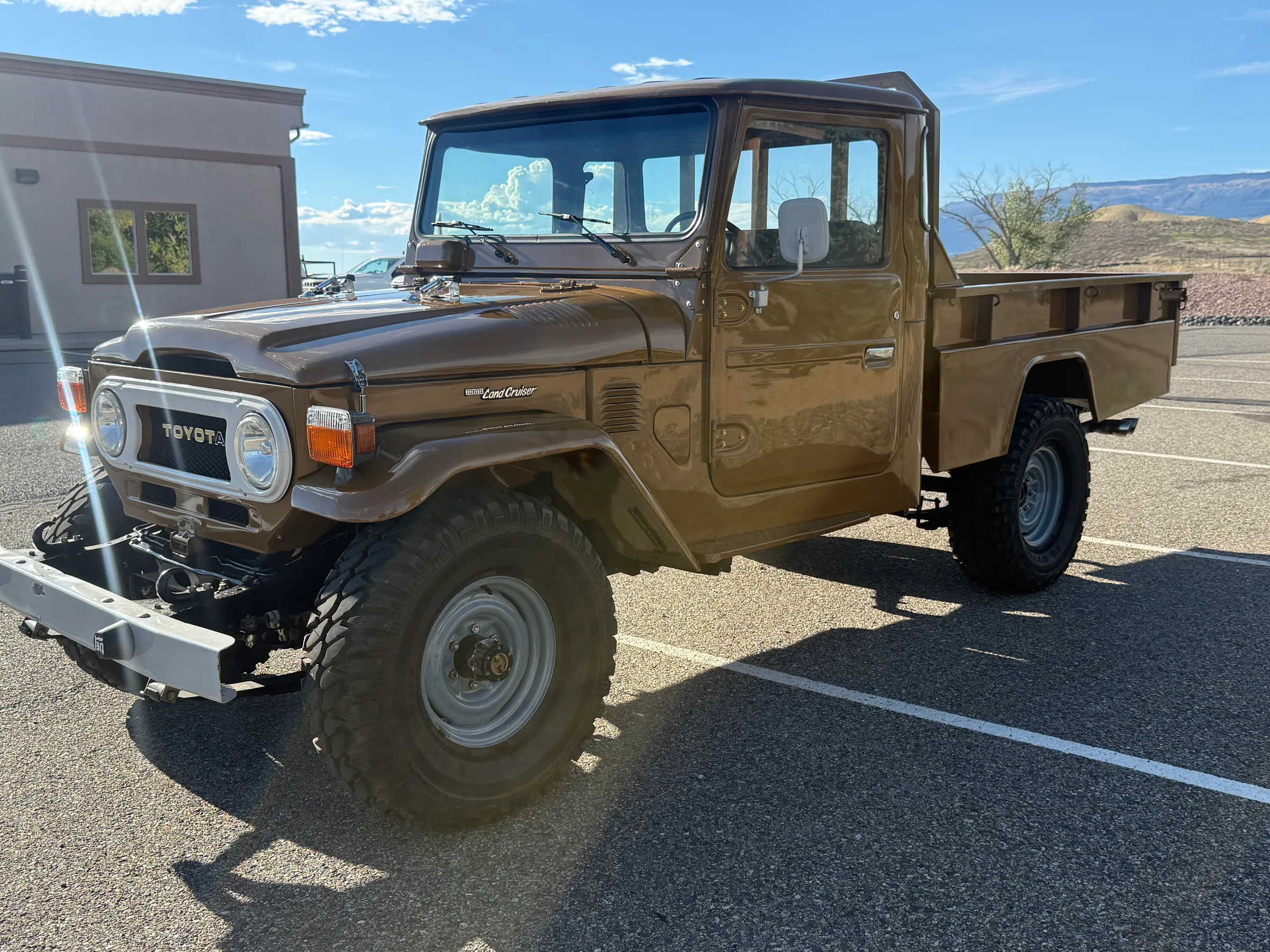 Front driver-side view of the brown FJ45 pickup