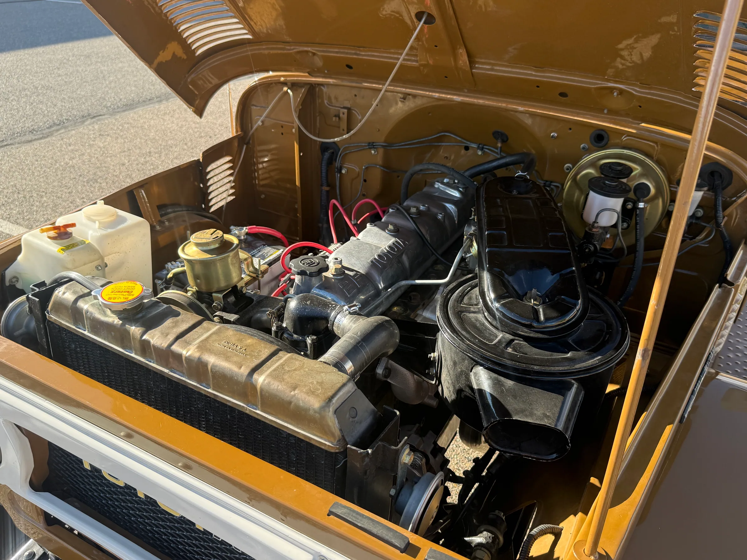 Engine bay, brake booster, and air cleaner on the 1978 FJ45