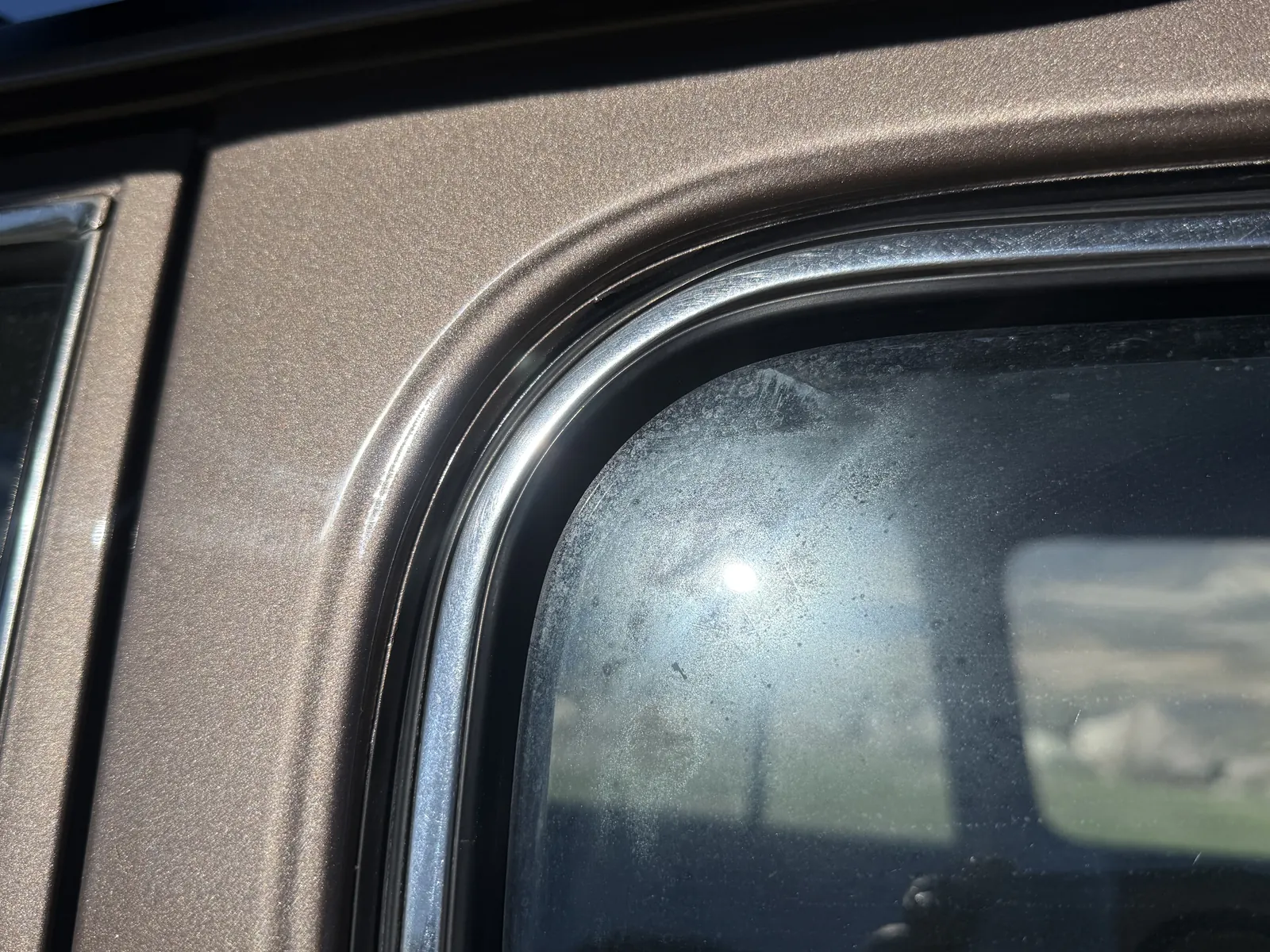 Overspray visible on the rear glass weatherstripping