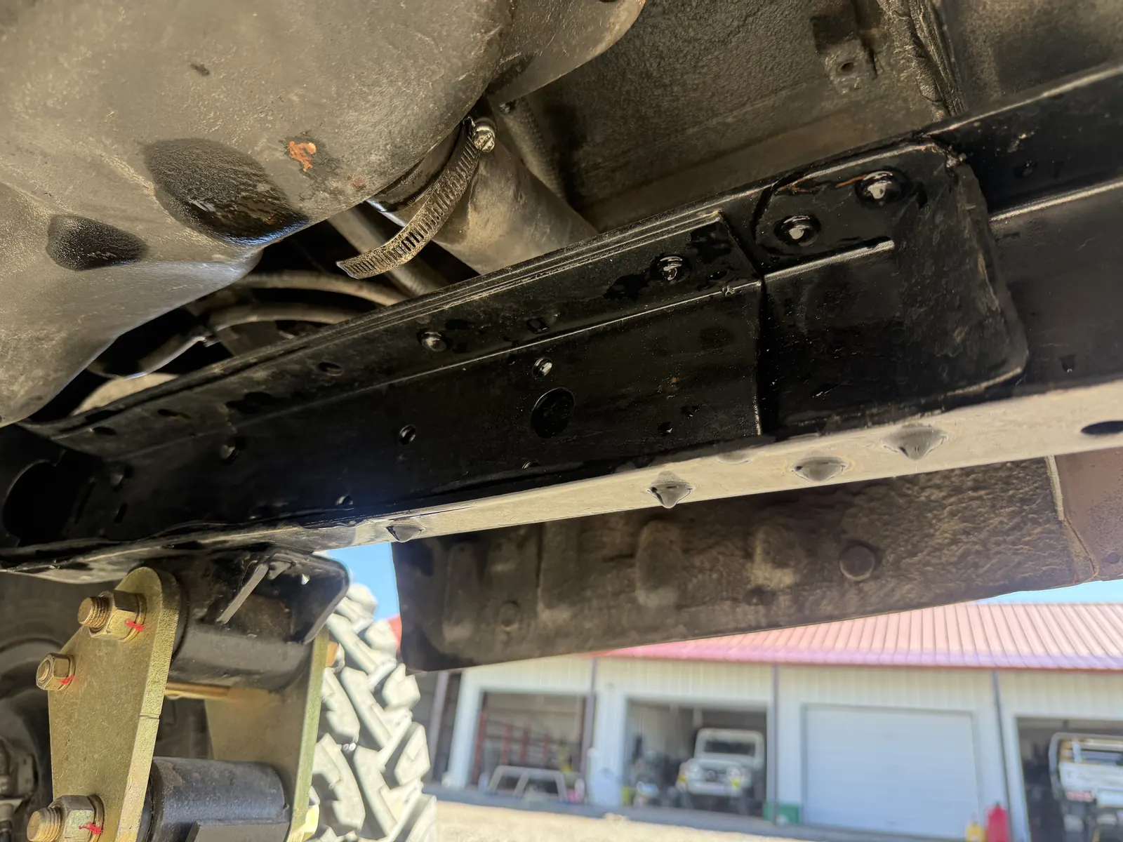 Welded suspension mounting bracket beneath the FJ60