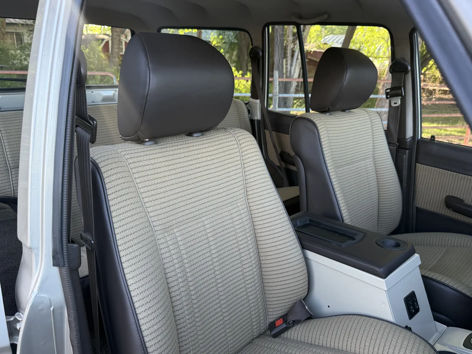OEM-replica cloth upholstery and 100 Series front seats