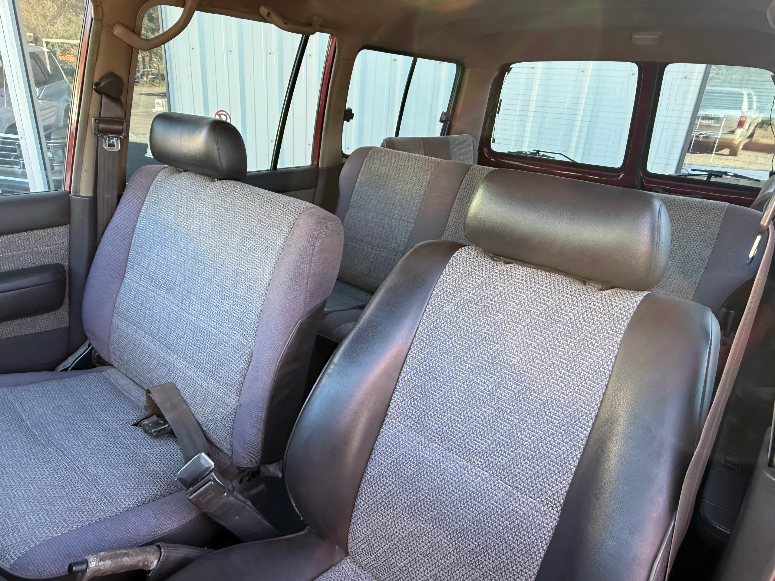 Gray cloth front seats inside the 1990 FJ80