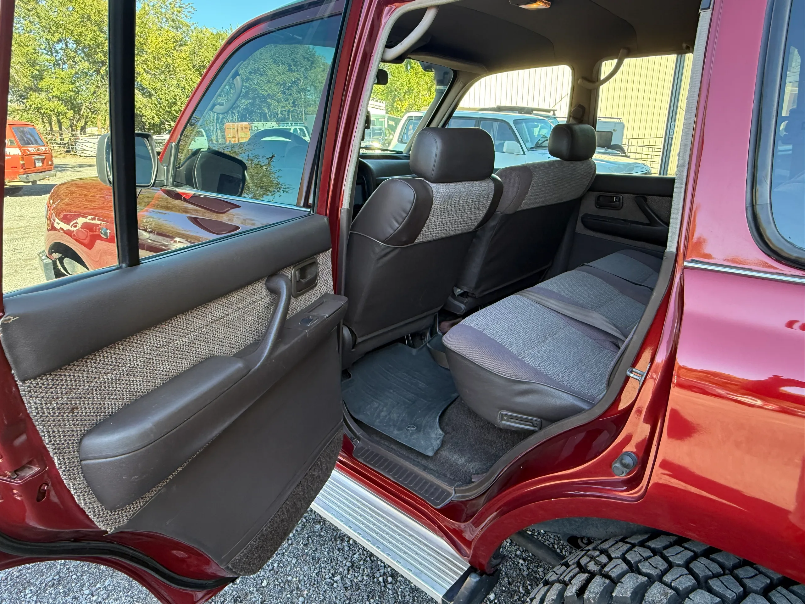 Second-row seating viewed through the open rear passenger door