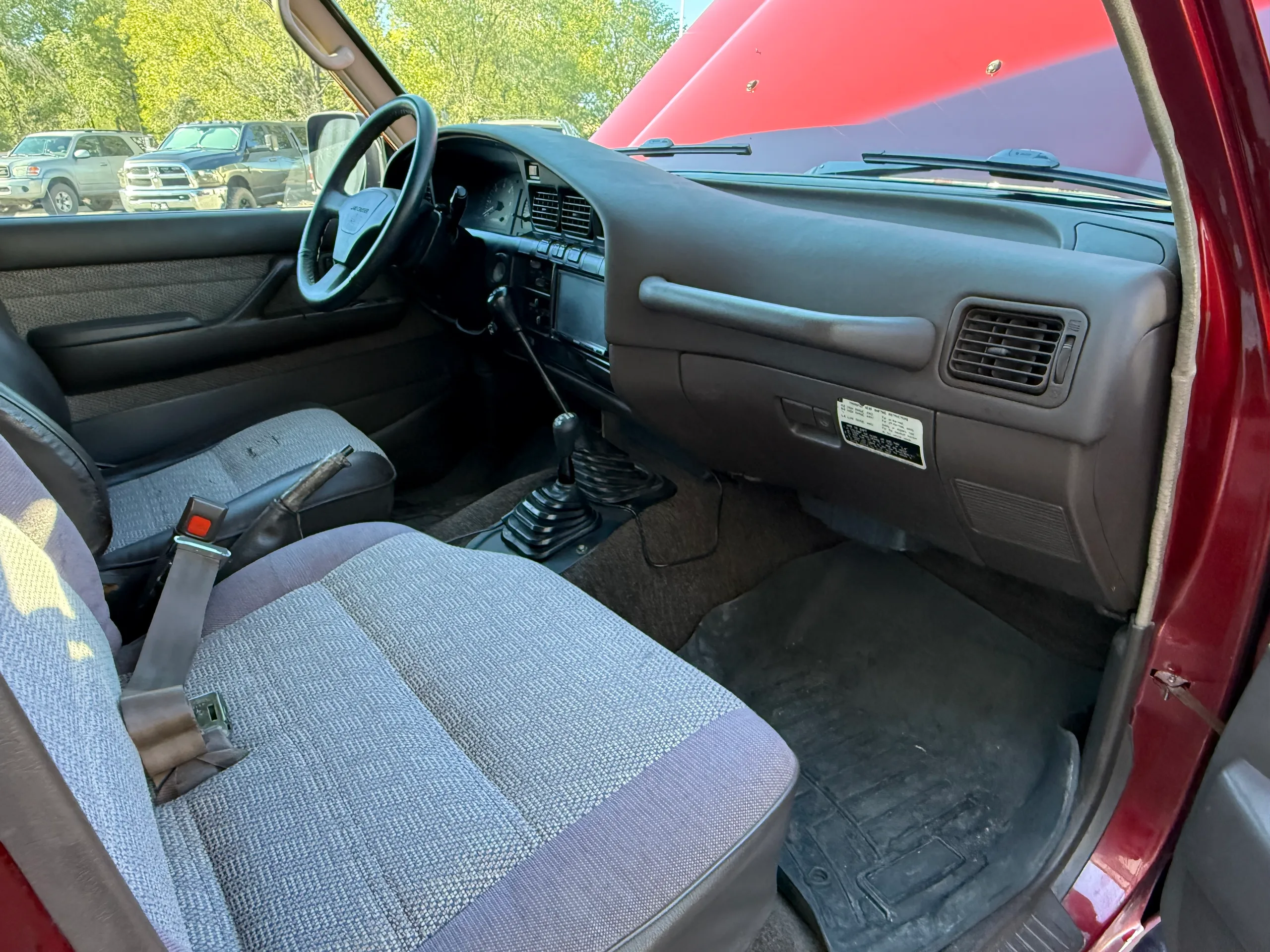 Front passenger seat, dashboard, and manual shifter in the FJ80