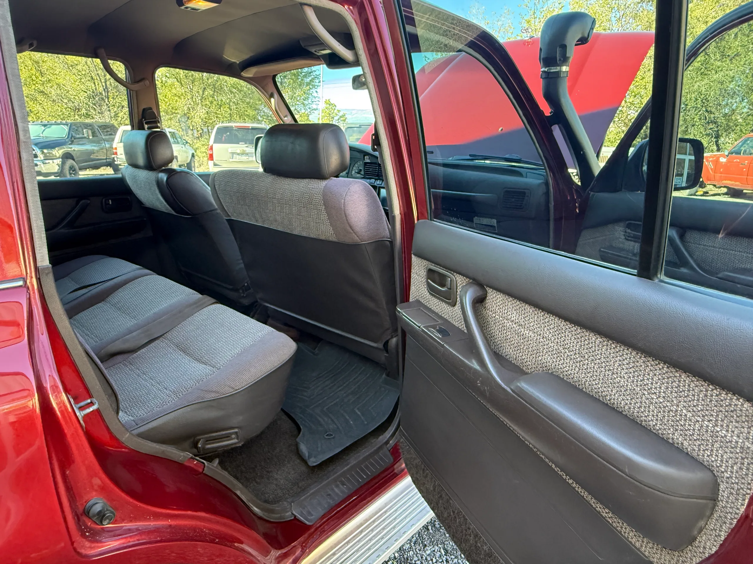Second-row bench seat viewed through the open driver-side rear door