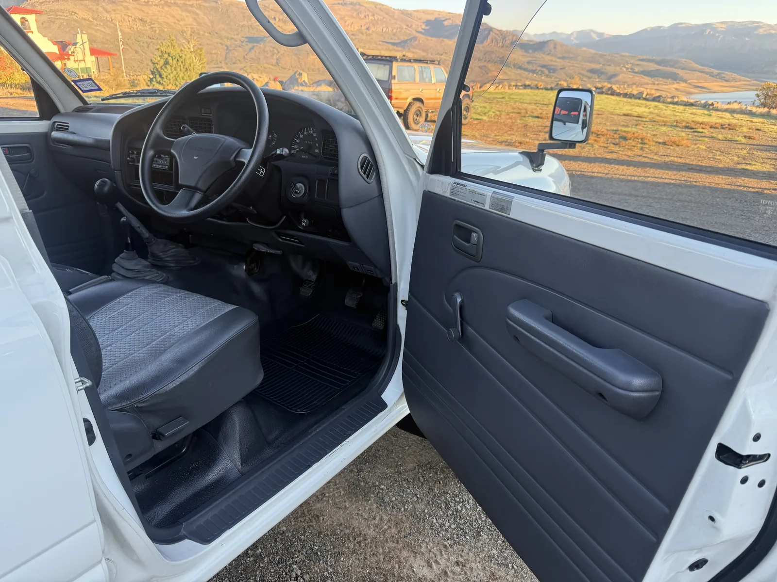 Open right-hand driver door and dashboard in the HZJ81