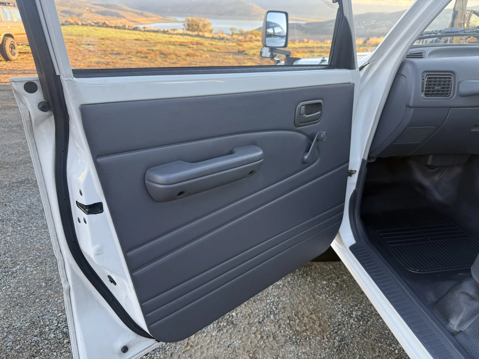 Gray vinyl front door panel with manual window crank