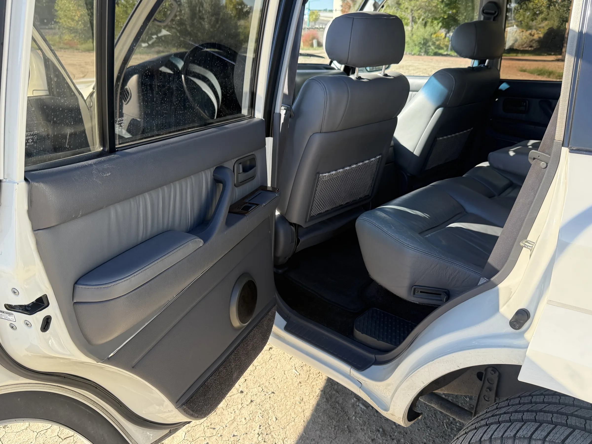 Open rear driver-side door and second-row seating in the 1994 FZJ80
