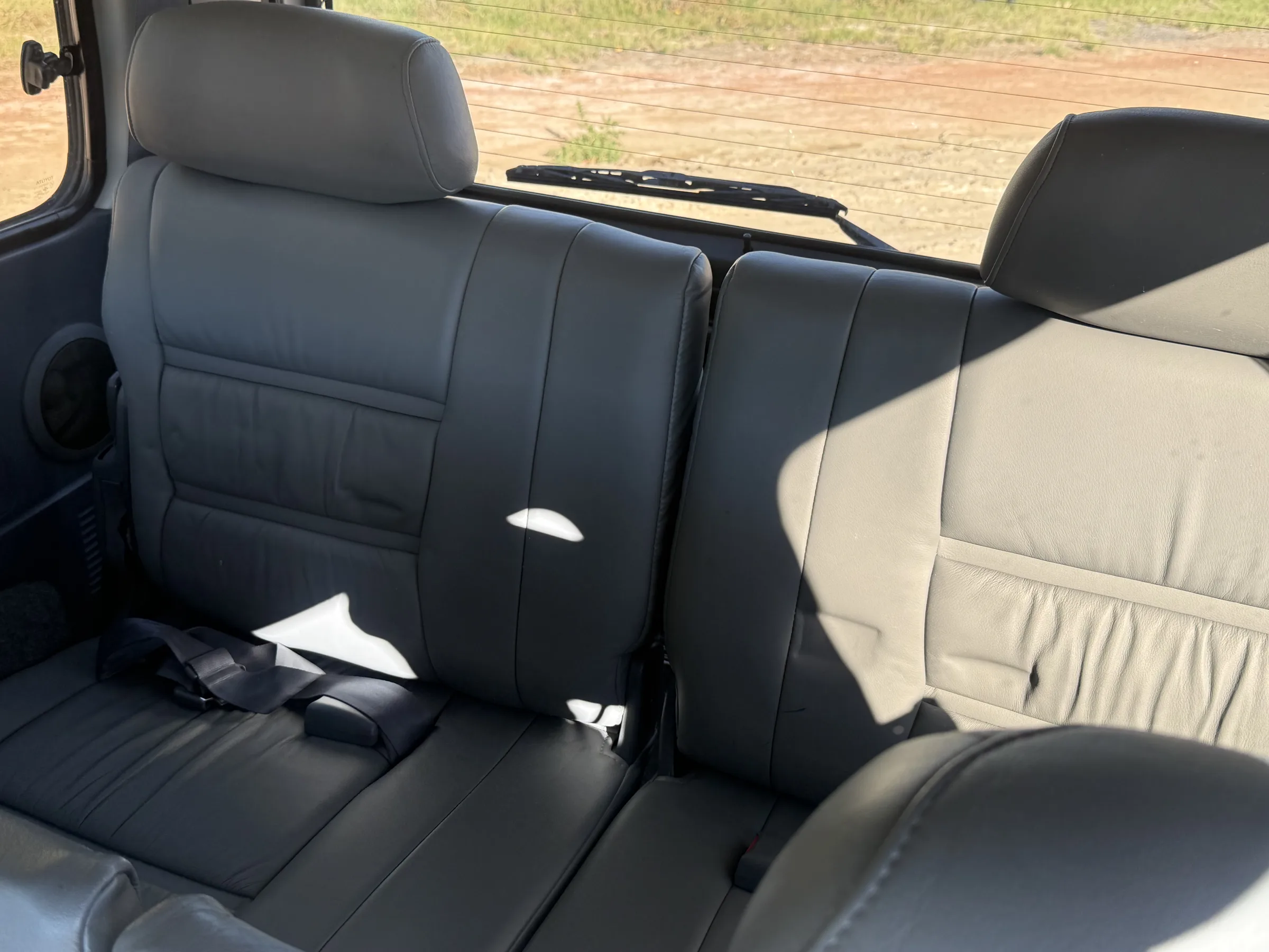 Gray leather second-row bench seat in the 1994 FZJ80
