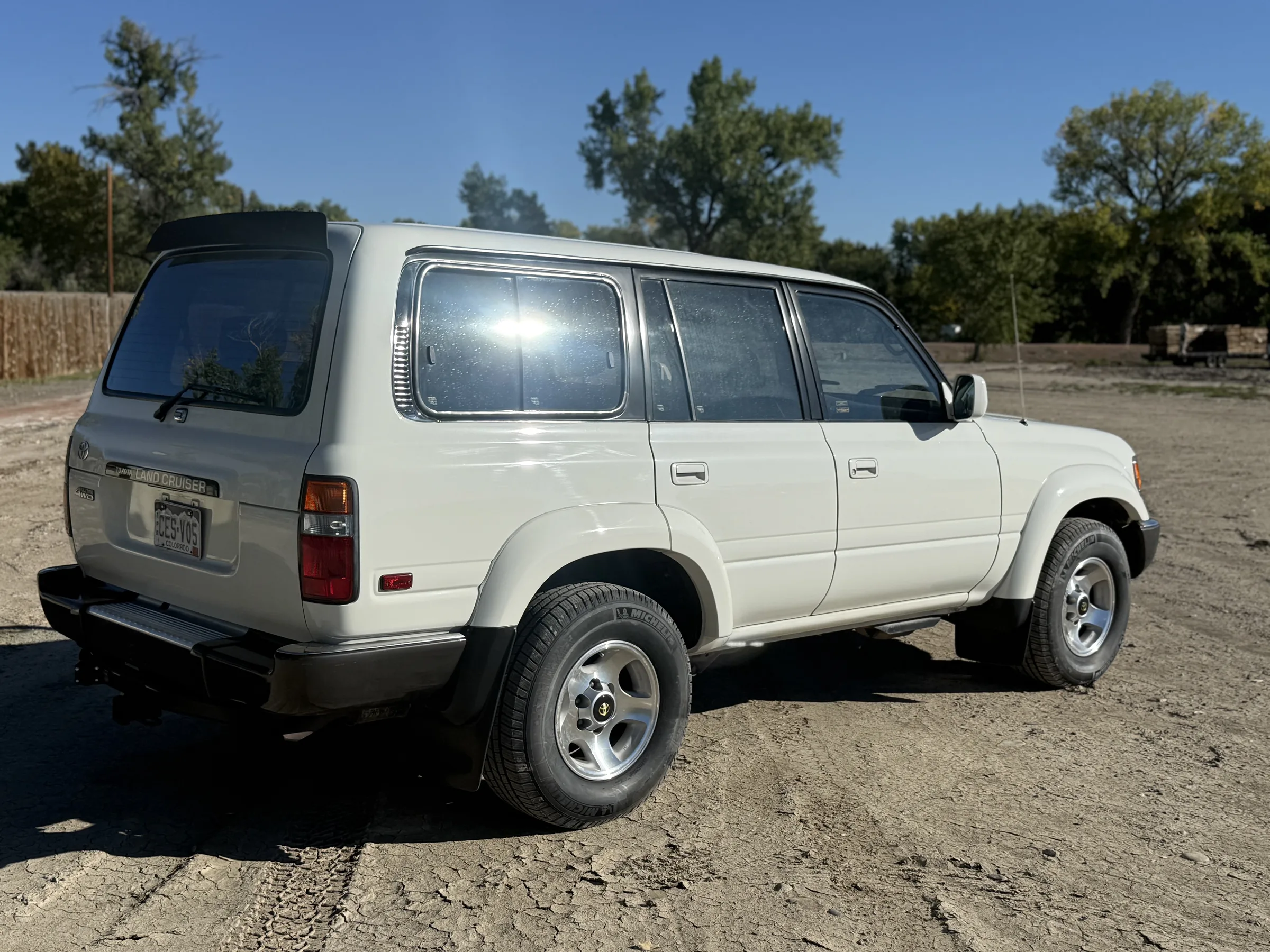 Rear passenger-side view of the white 1994 FZJ80