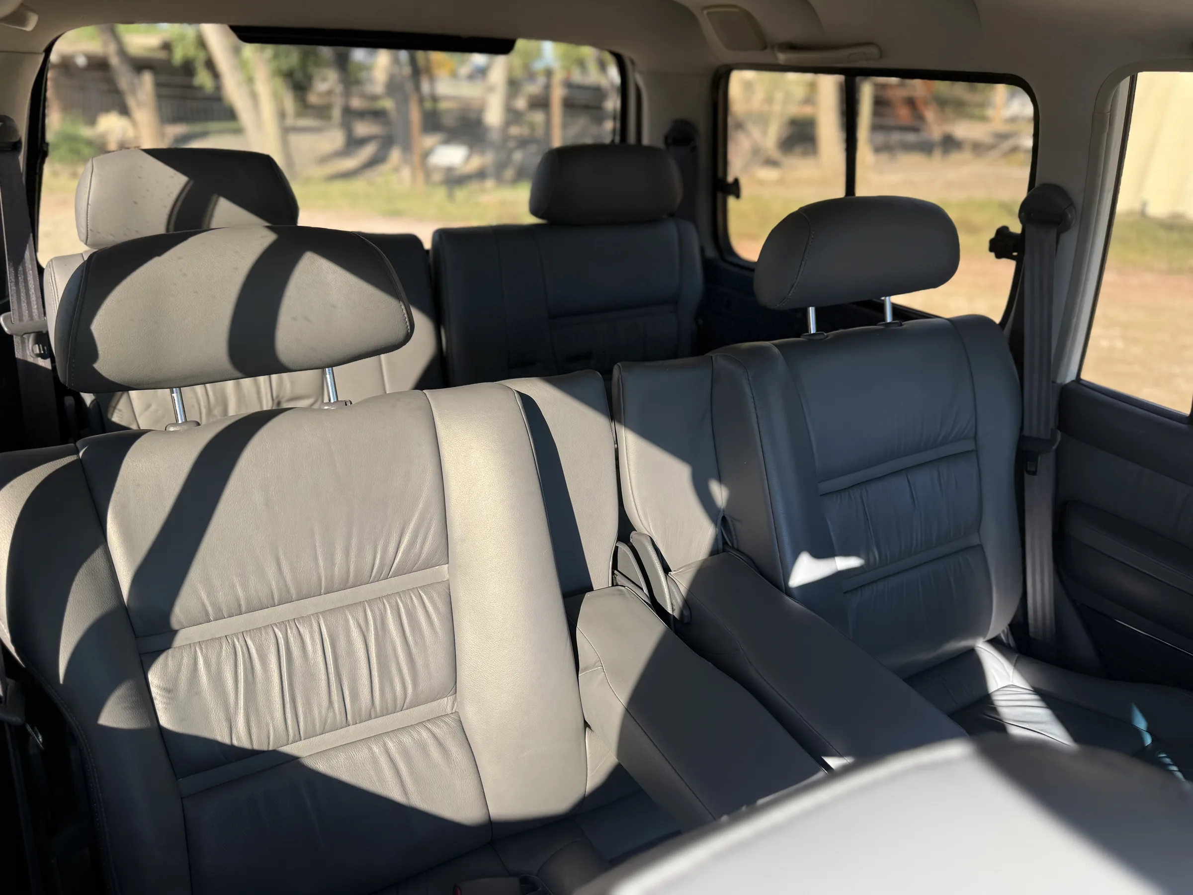 Three rows of gray leather seating in the 1994 FZJ80