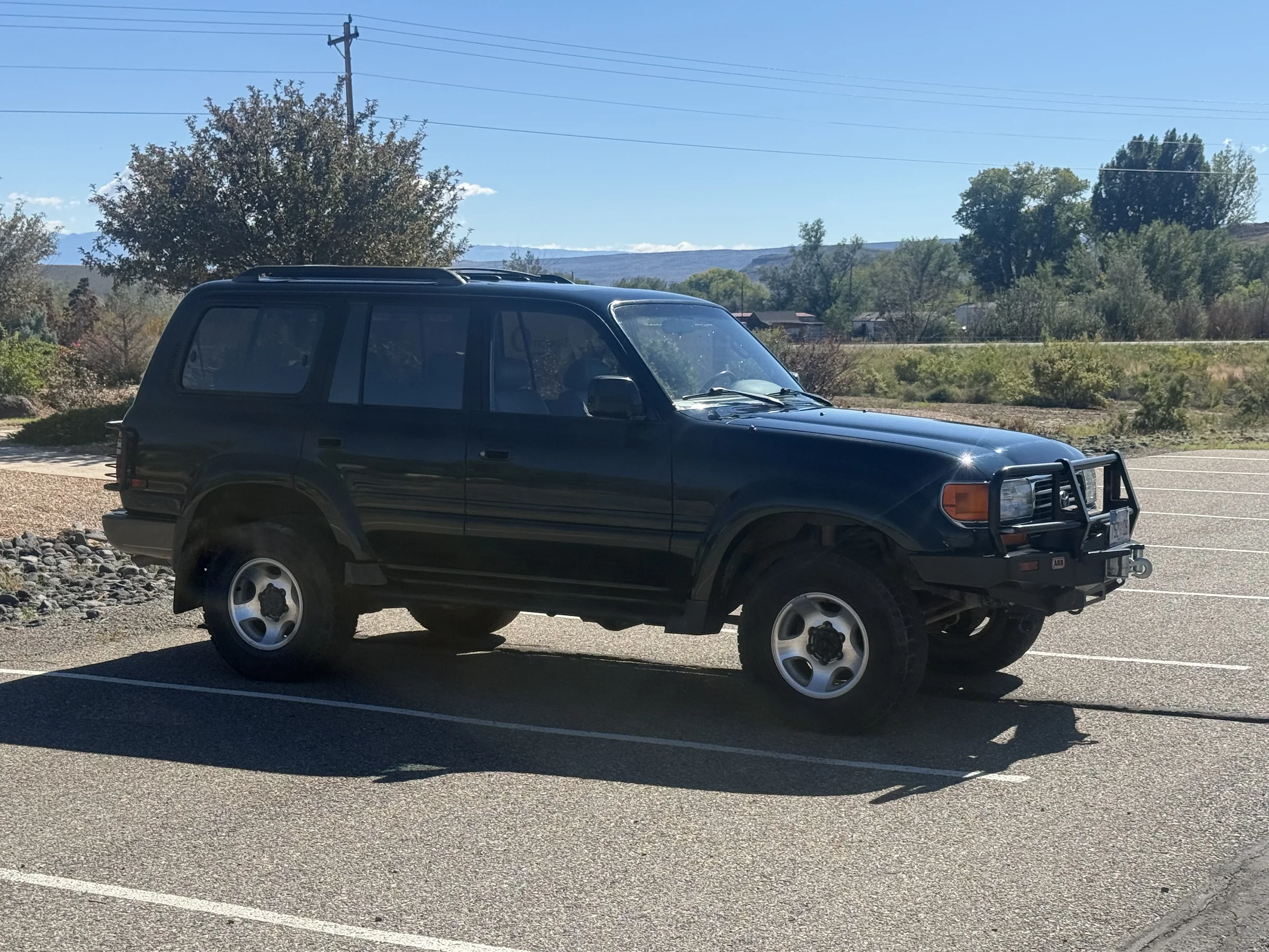 Front side view of the green 1996 Toyota Land Cruiser FZJ80