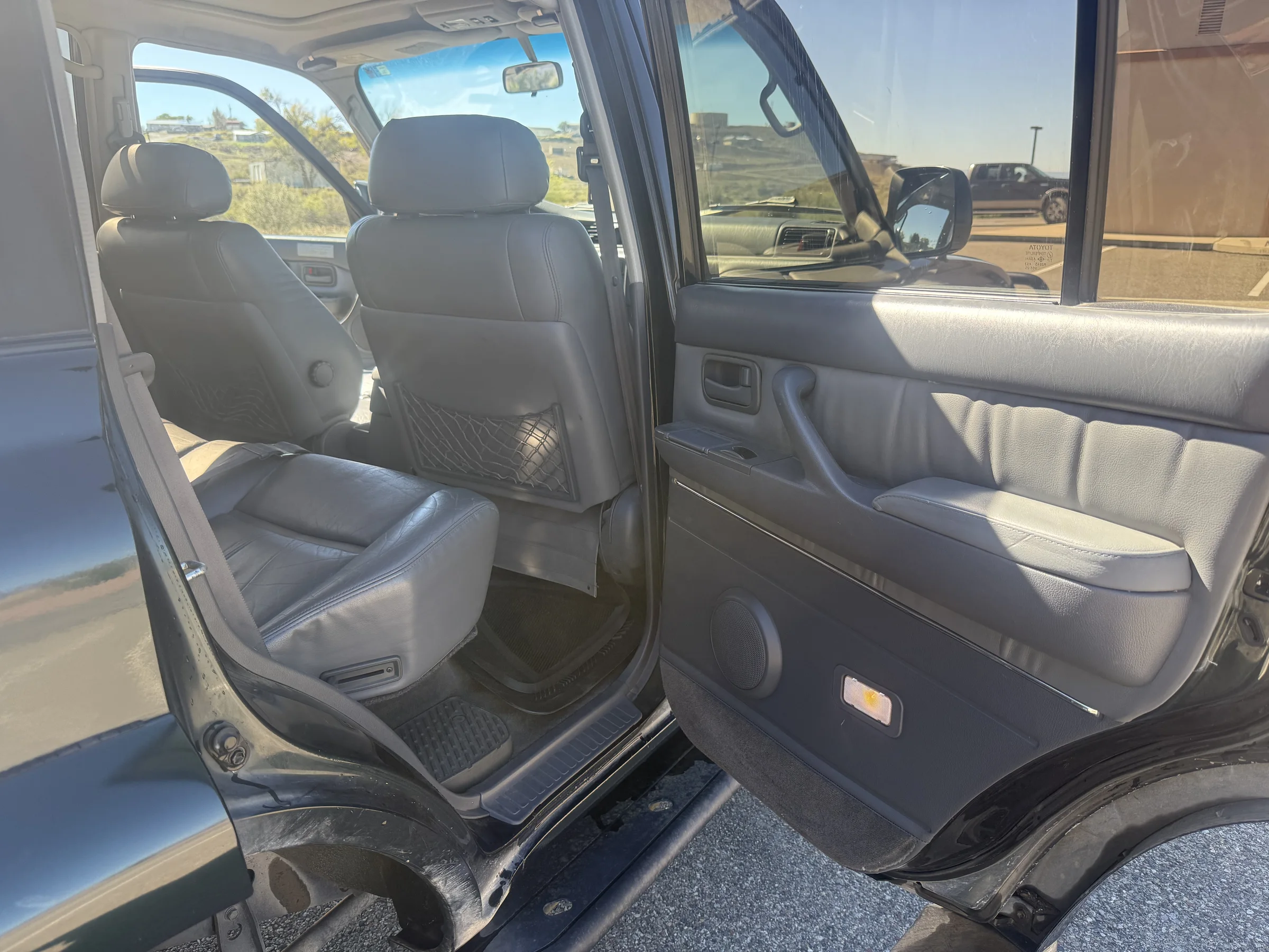 Open rear passenger door and second-row seating in the 1996 FZJ80