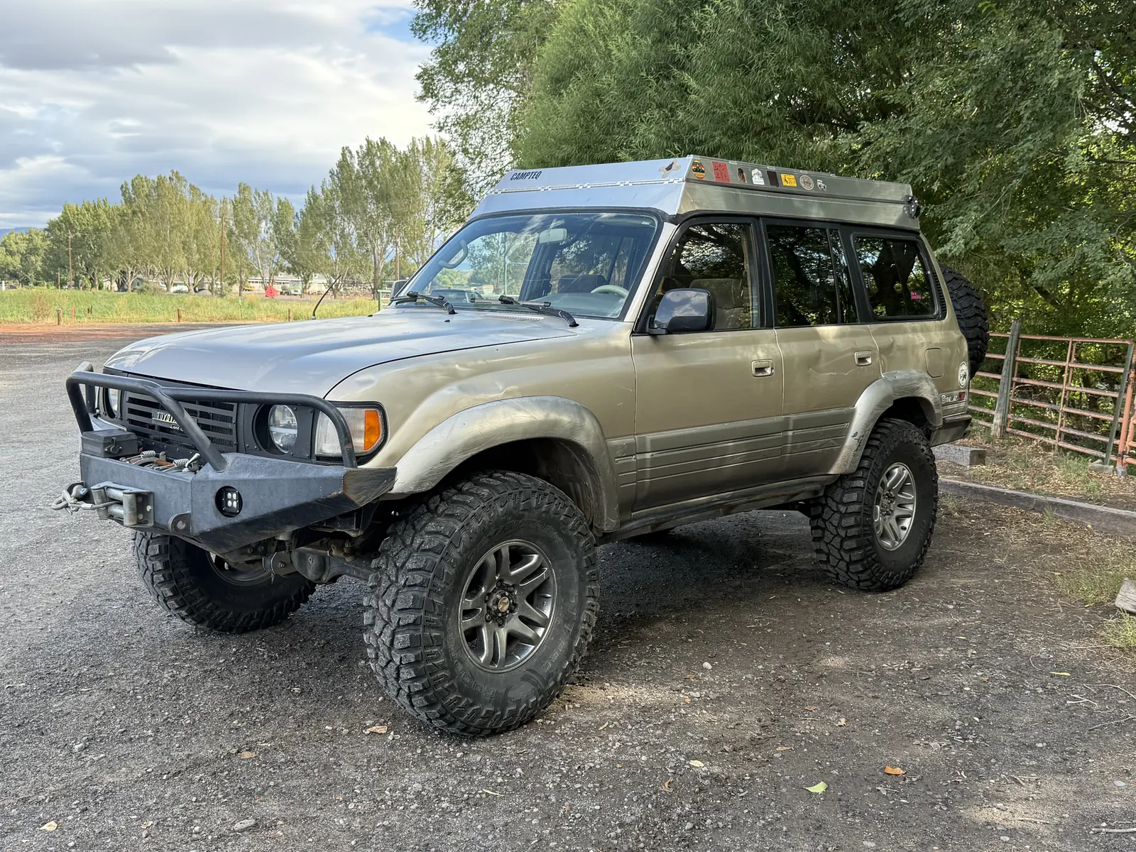 Front driver-side view of the lifted 1997 Lexus LX450 with pop-top roof