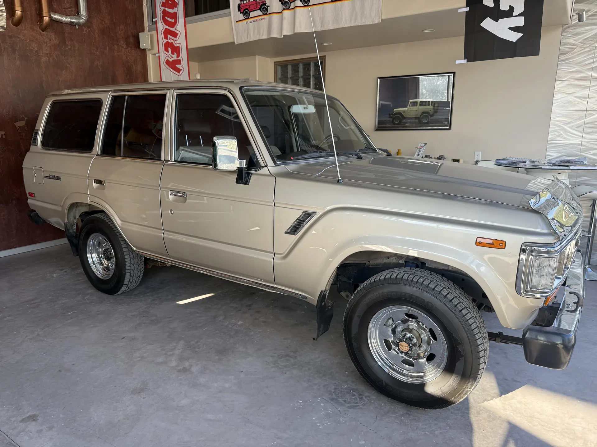 Front passenger-side view of the 1990 Toyota FJ62 Land Cruiser inside the shop